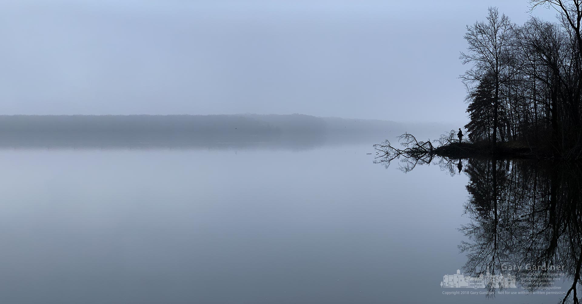 A lone fisherman stands near the end of a point of land jutting out into the morning fog from Red Bank Park early Friday. My Final Photo for Nov. 30, 2018.