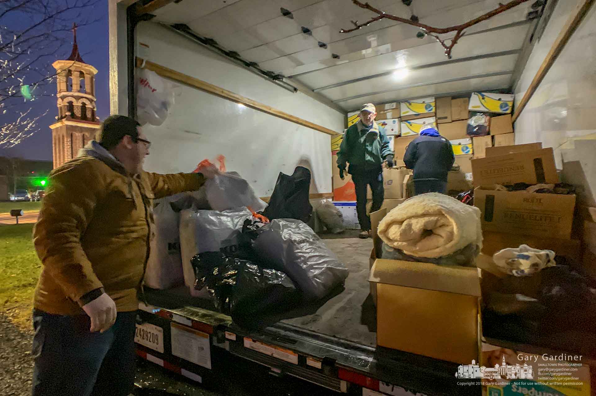 Volunteers gather coats and blankets in front of St. Paul the Apostle Catholic Church as donations for delivery to a charity in Kentucky for distribution at Christmas. My Final Photo for Dec. 16, 2018.