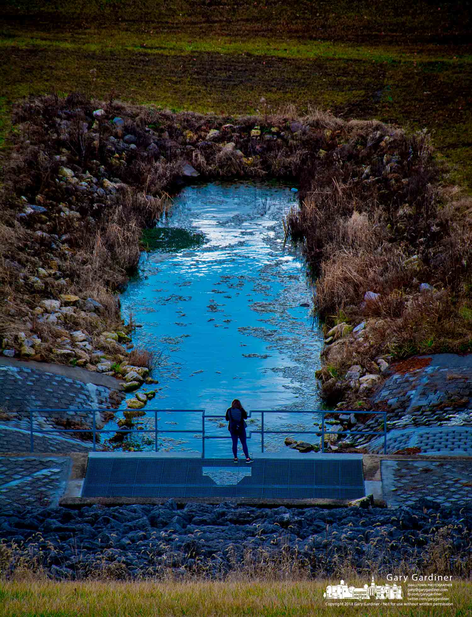 A photographer stands on a spillway cover to photograph the afternoon sky at the base of Hoover Dam in Columbus. My Final Photo for Dec. 28, 2018.