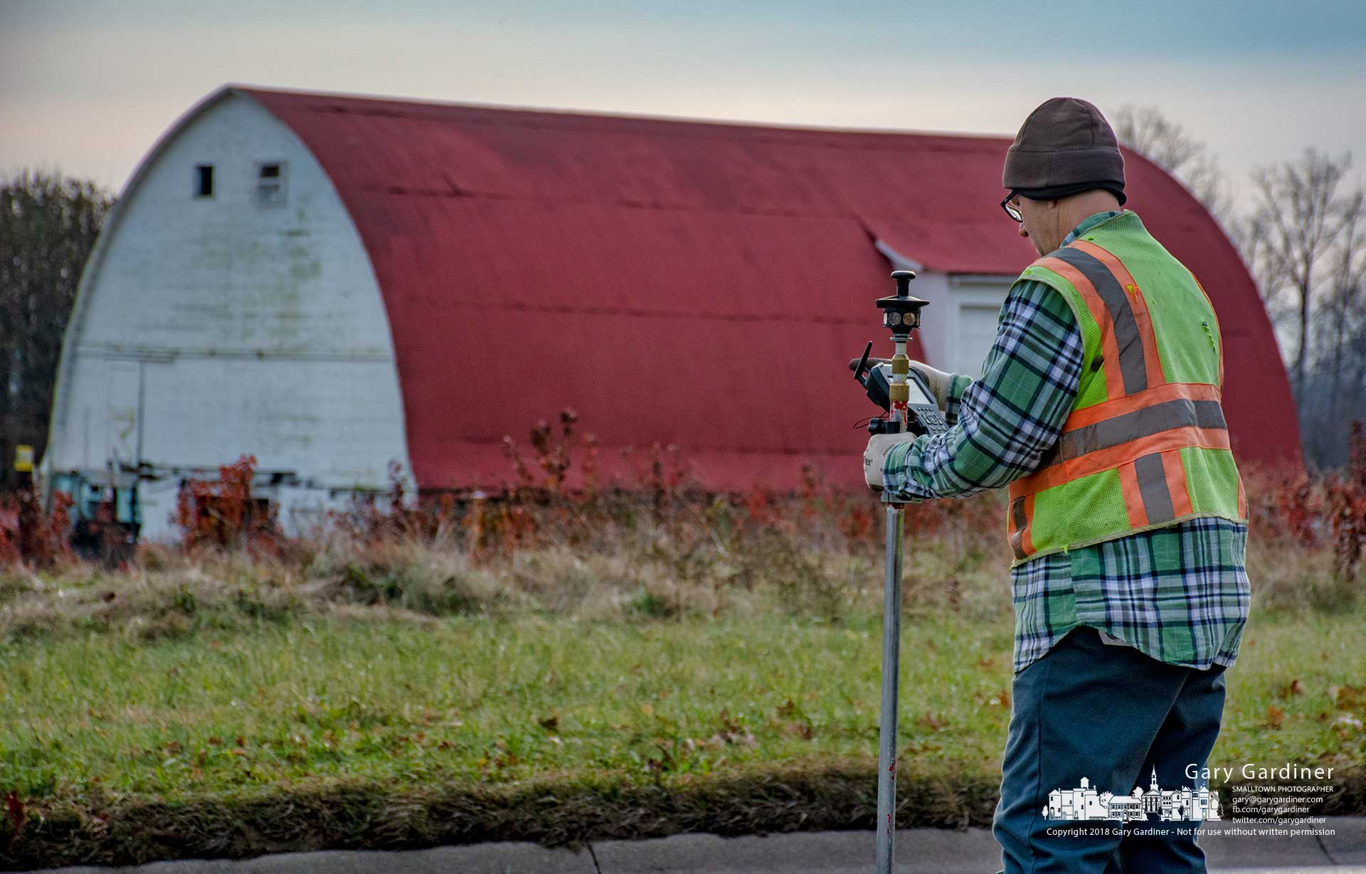 A surveyor measures elevations and locations along Cleveland Avenue near Cooper Road as part of a survey of land including Otterbein's hay fields and the Braun Farm. My Final Photo for Dec. 6, 2018.