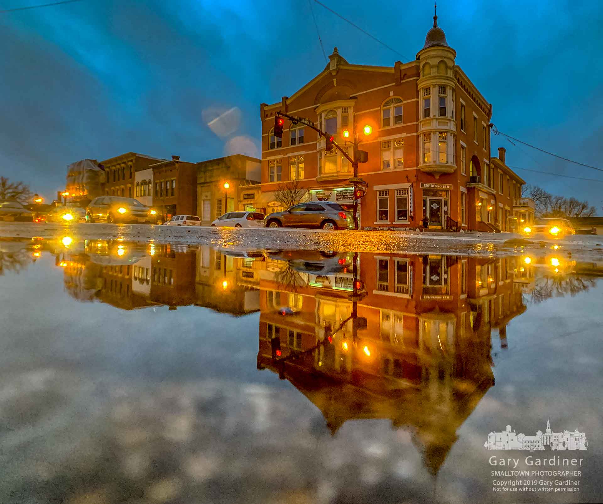 The Holmes Hotel in Uptown Westerville is reflected in puddles gathering in the street after a day of rain melted most of the snow and added to the gathering groundwater. My Final Photo for Jan. 23, 2019.
