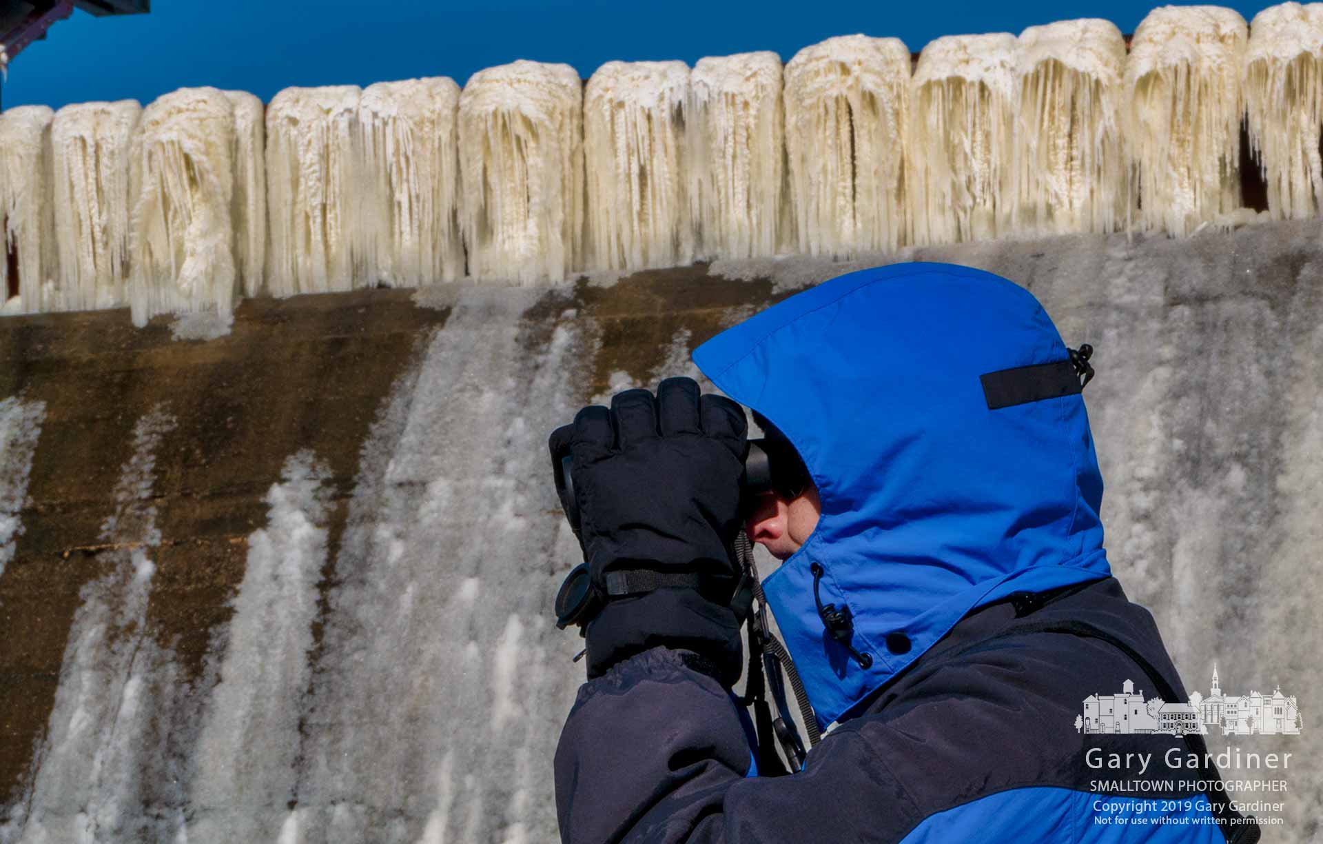 A birdwatcher looks downstream below Hoover Dam where the spillway edges are covered in sheets of ice from the below freezing nights. My Final Photo for Jan. 31, 2019.