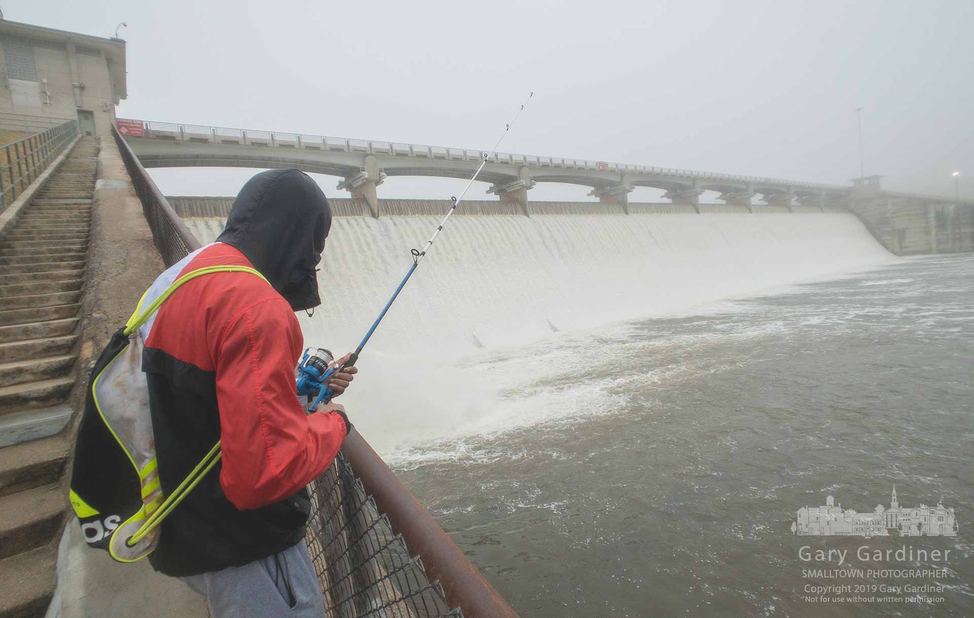 An angler tests the waters below the fog-shrouded Hoover Dam where heavy runoff from melting snow flows into Big Walnut Creek. My Final Photo for Feb. 5, 2019.
