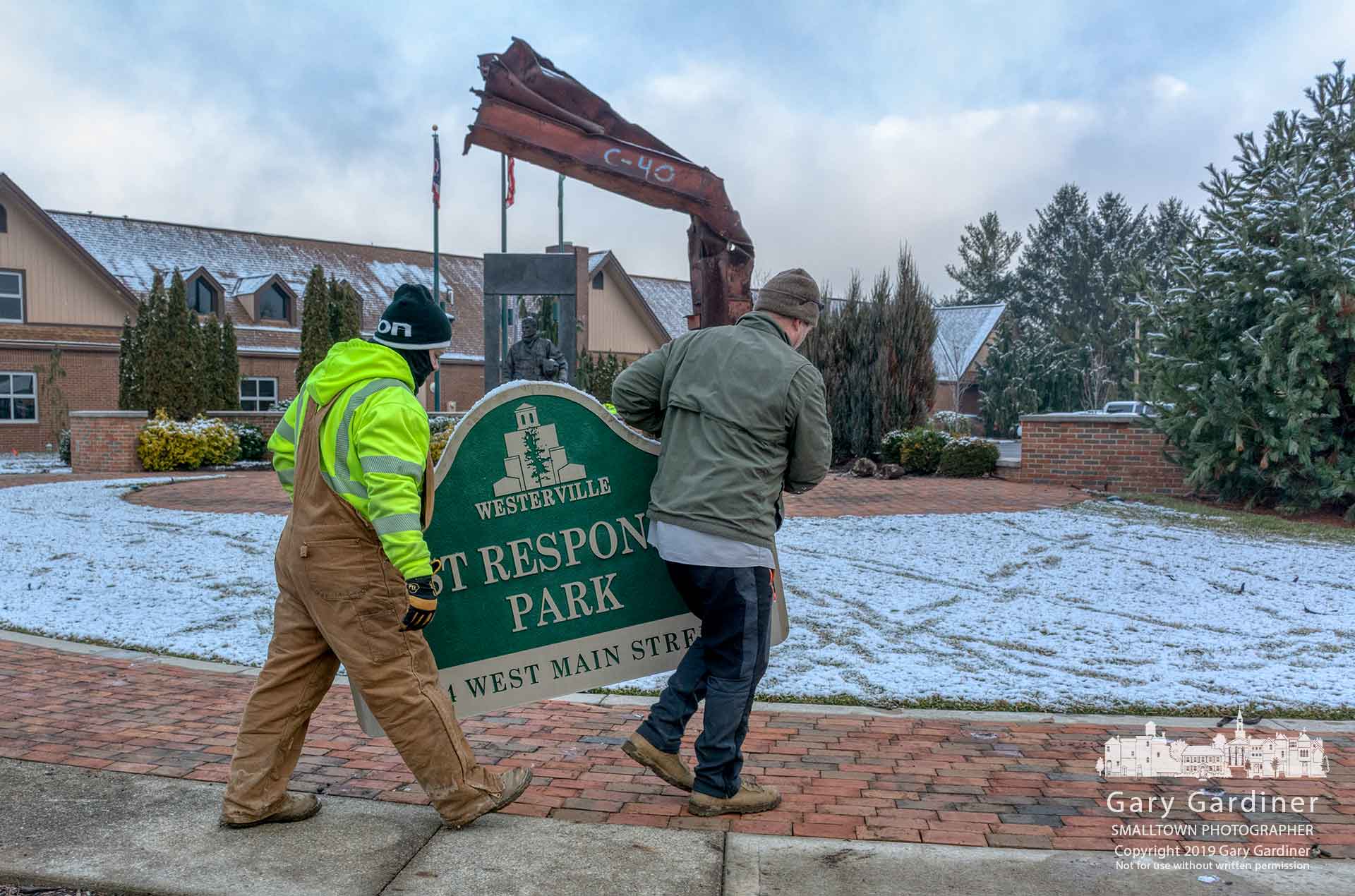 Westerville Parks workers remove the First Responders Park sign as contractors prepare to expand the original park to add a memorial for the two police officers killed in 2018. My Final Photo for March 19, 2019.