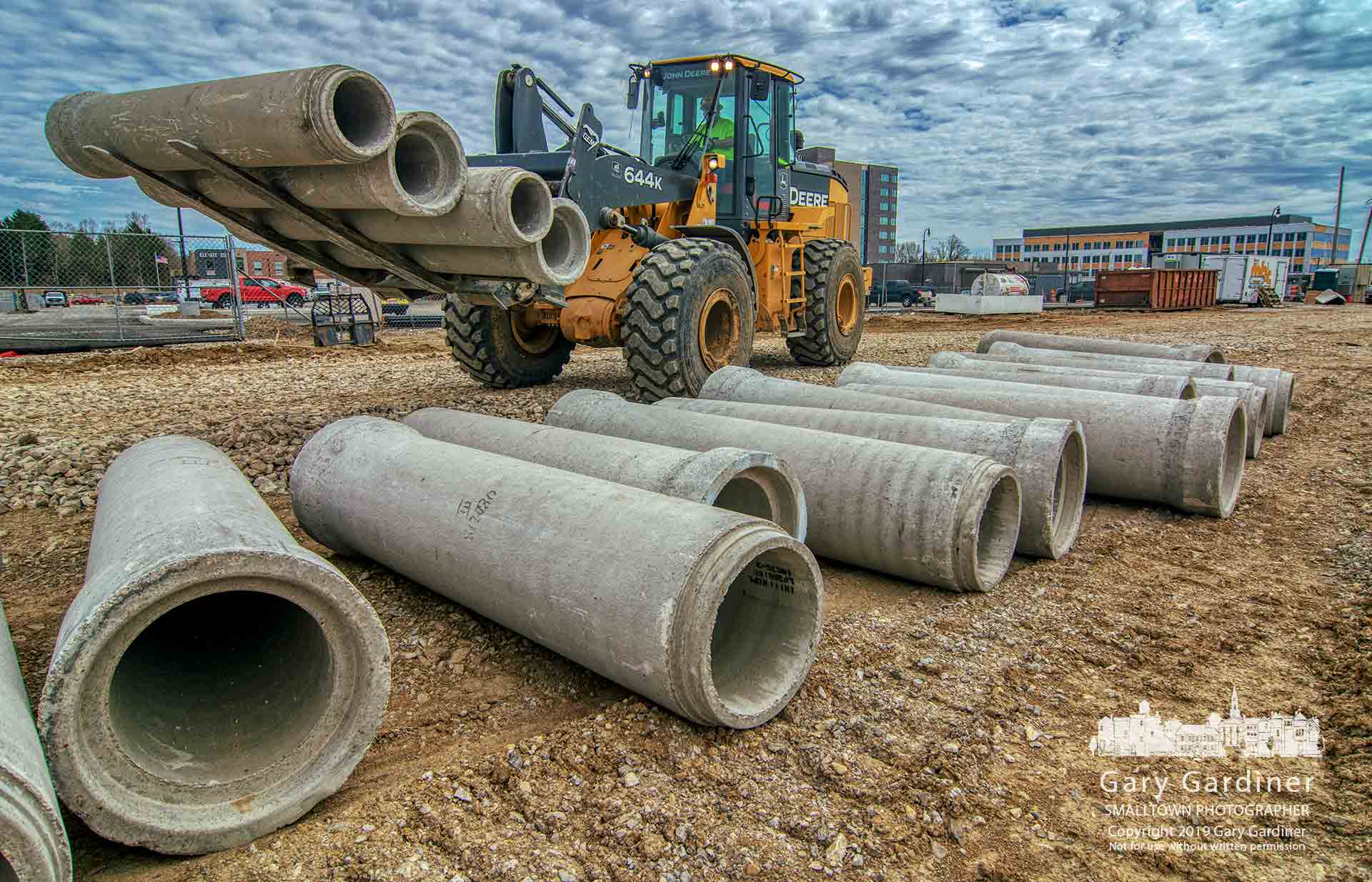 Preparing For The Storm - Storm sewer pipes destined for two new roads in the Westar development are moved along one of the new roadways Wednesday afternoon. My Final Photo for April 10, 2019.