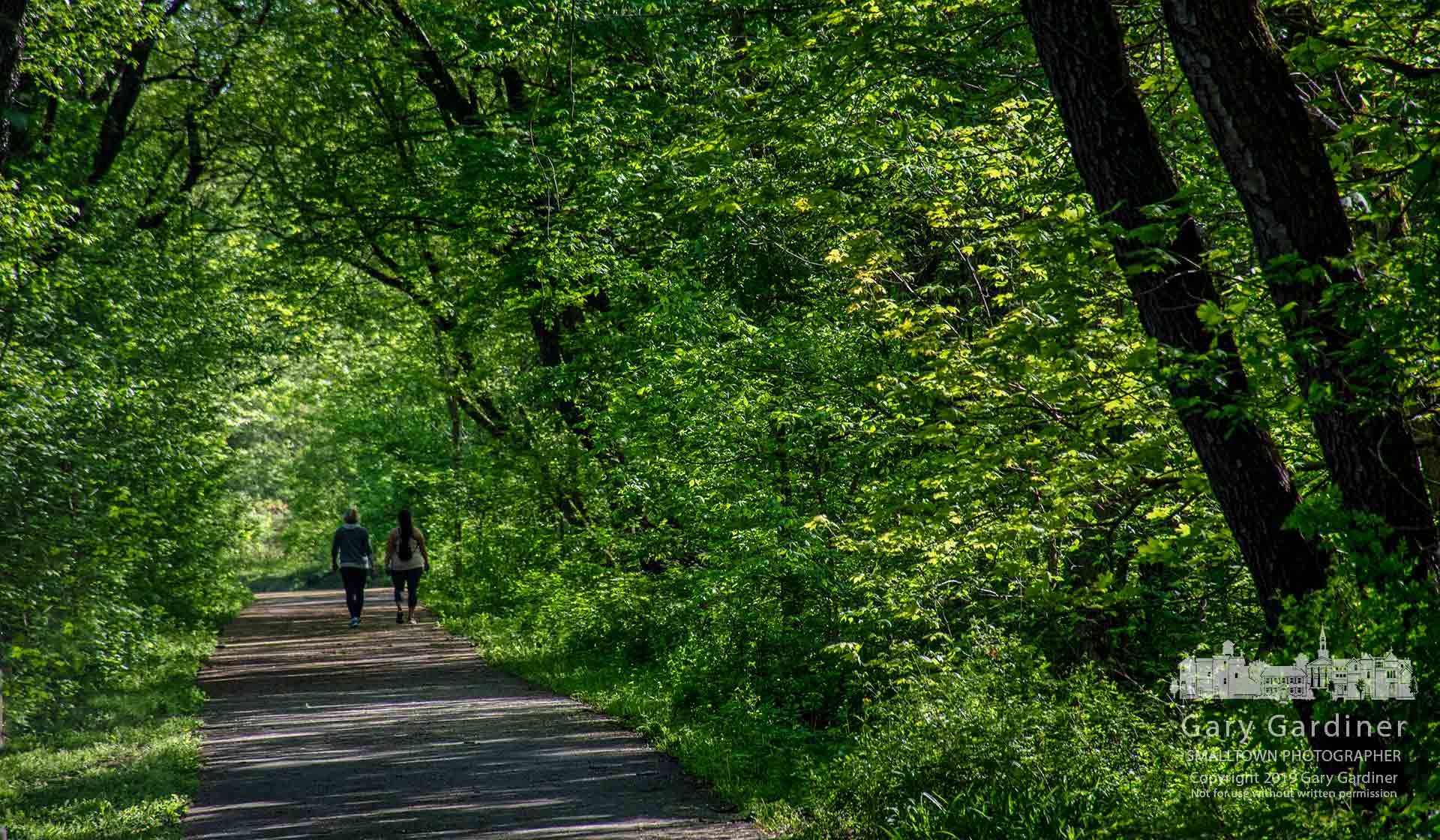 Two women walk a section of the Ohio to Erie Trail on the old railroad right-of-way across Big Walnut Creek in Galena. My final Photo for May 5, 2019.