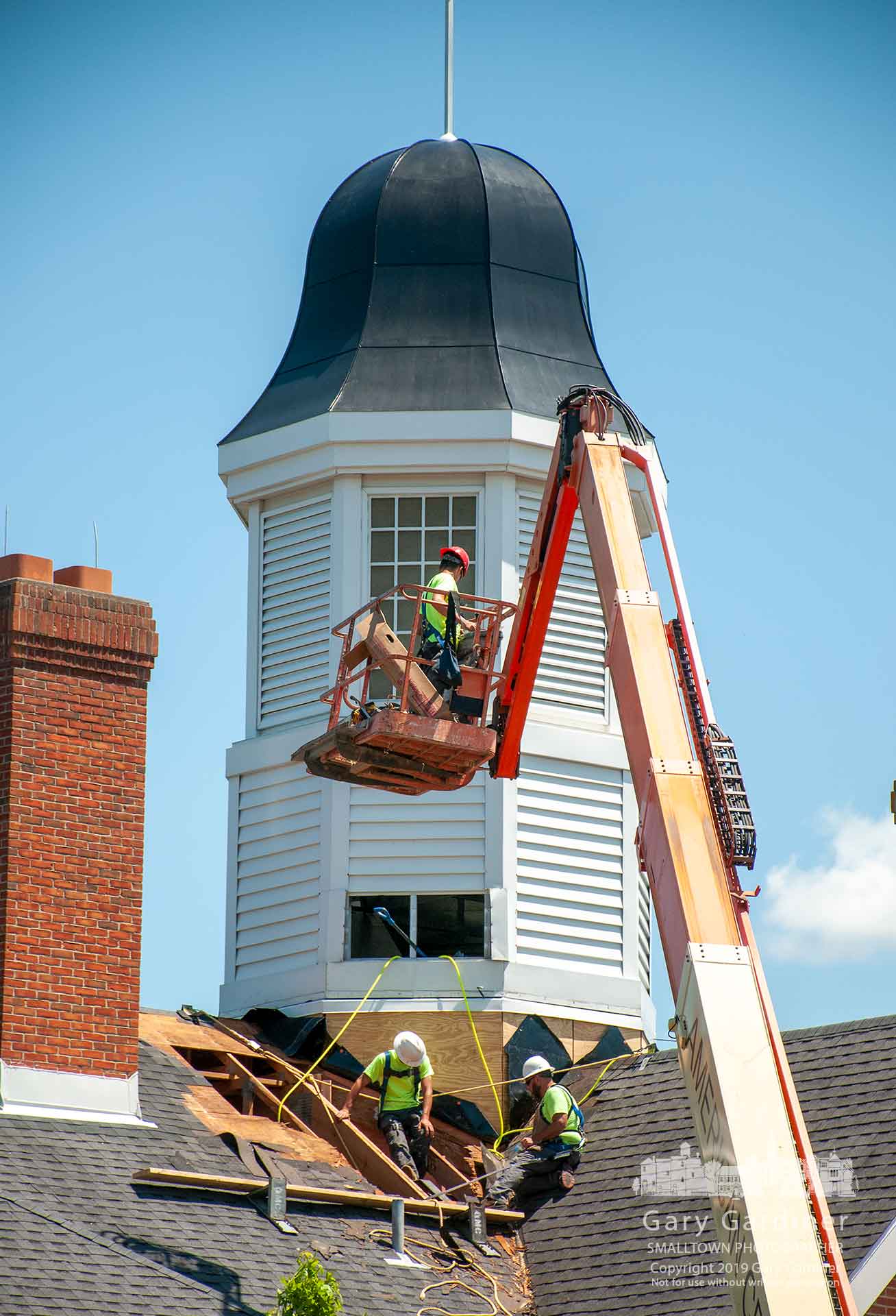 The construction crew works to complete repairs of the support and roofing at the base of the cupola at city hall after replacing it over the weekend at the end of the second phase of the project. My Final Photo for June 3, 2019.