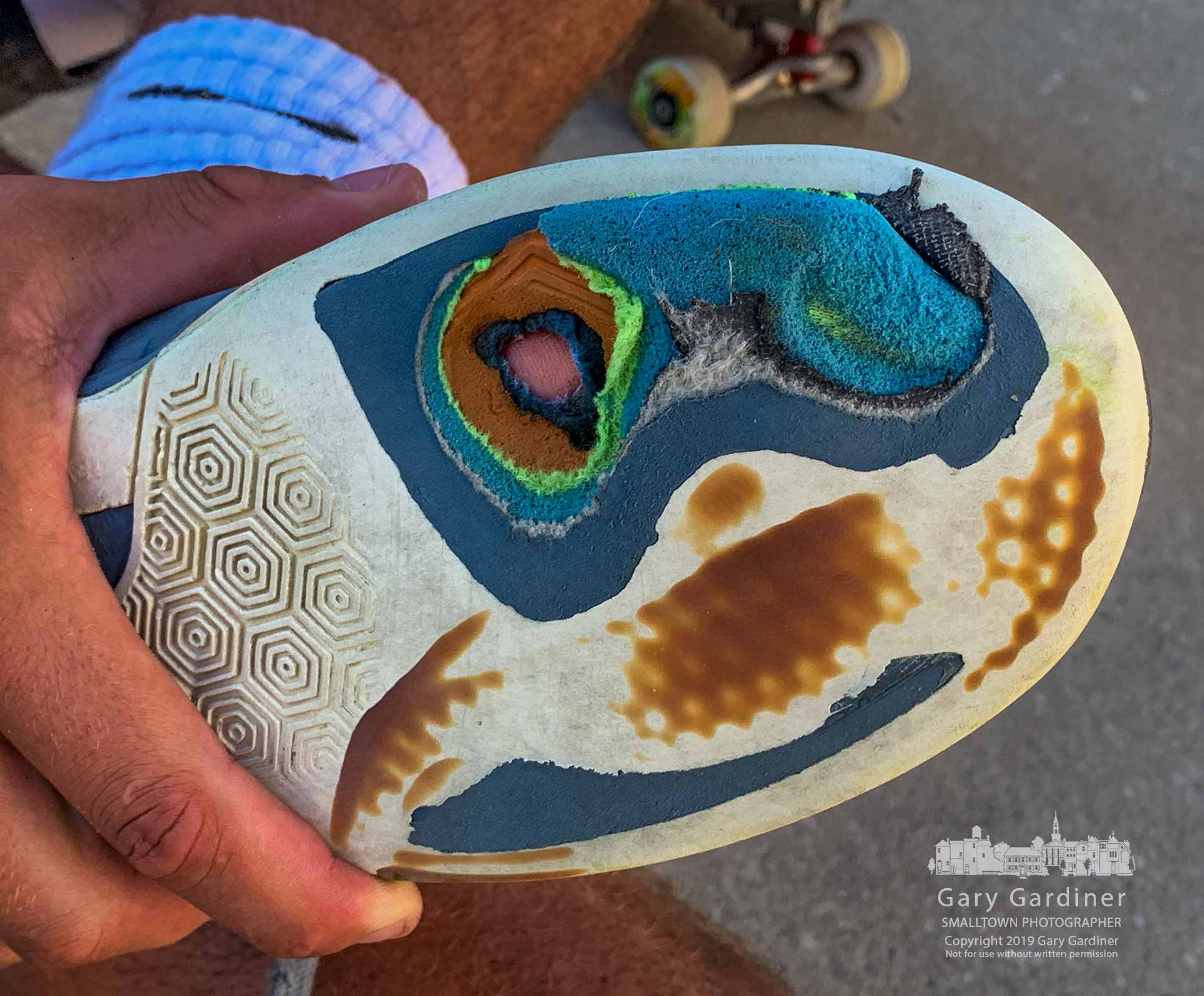 A skateboarder shows how the bottom of his foot shows through the sole of his skating shoes after a missed trick at the Westerville Skatepark further damaged the shoe and his foot. My Final Photo for Aug. 4, 2019.