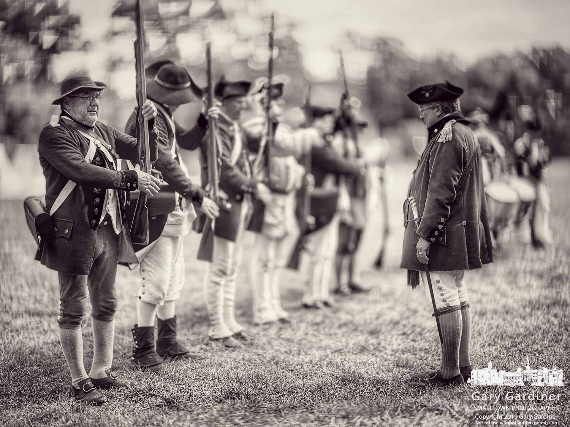 Revolutionary War reenactors move into the "present arms" position for the small crowd that gathered after morning rain at Heritage Park in Westerville for the first of two days of reenactments of soldiers battles, cannon fire, a physician explaining his methods, and the company cook preparing pork over an open fire. My Final Photo for Sept. 21, 2019.