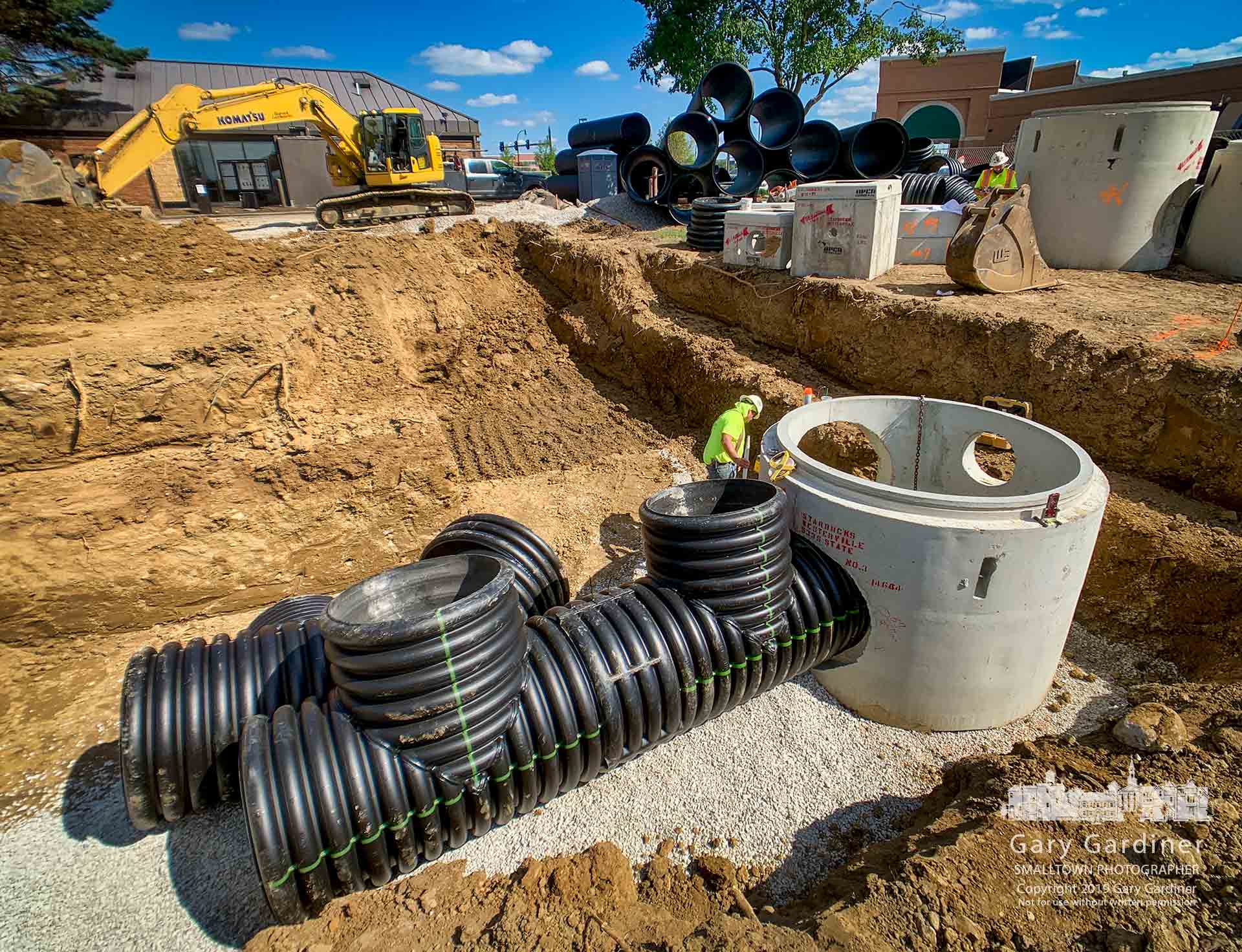 A contractor checks the alignment of corrugated pipes being laid as part of the underground holding tank for storm runoff at the rear of Starbucks on South State where the company is building a new drive-thru and parking lot at the rear of the building. My Final Photo for Sept. 4, 2019.