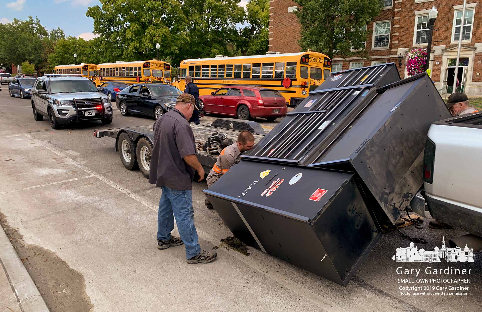 Workers for V.A.T., Inc. work to right a toolbox that slipped from its moorings on a trailer and tumbled onto State Street in front of Hanby Elementary. My Final Photo for Sept. 20, 2019.
