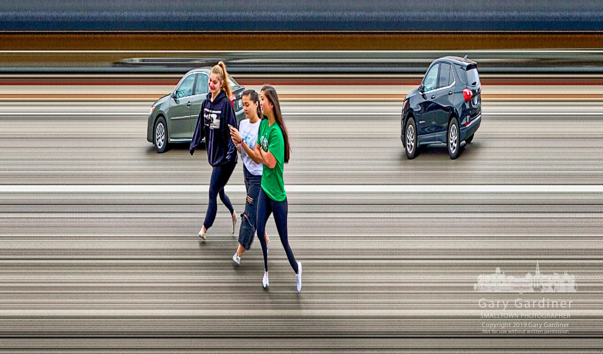 A trio of teenage girls walk across State Street where they spent part of Black Friday afternoon shopping in the Uptown district of Westerville. My final Photofor Nov. 29, 2018.