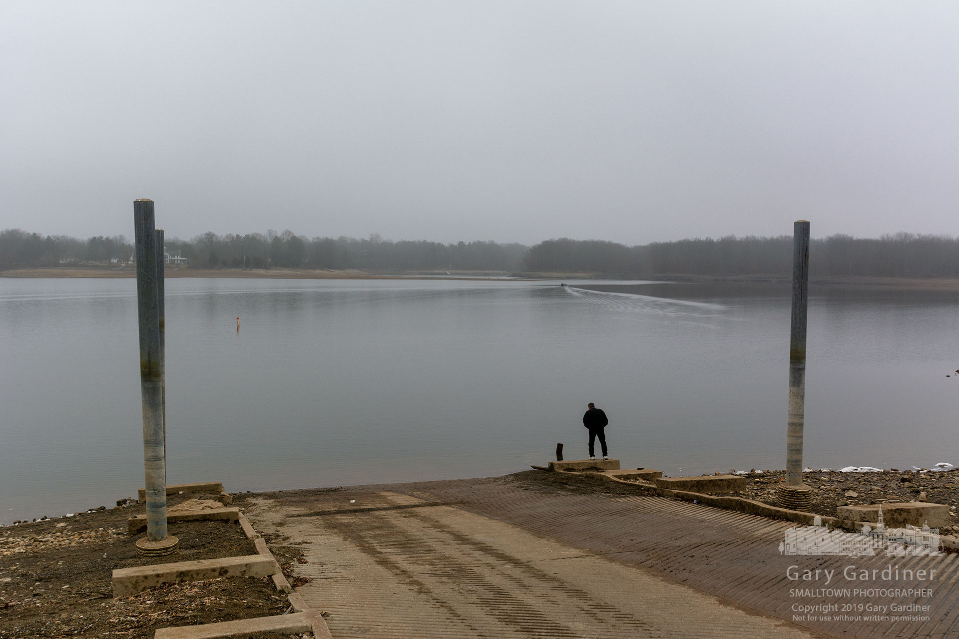 An angler checks the water level and depth at the end of the Red Bank boat ramp as he prepares himself and his gear for a day of winter fishing on the low and unfrozen water at Hoover Reservoir. My Final Photo for Dec. 28, 2019.