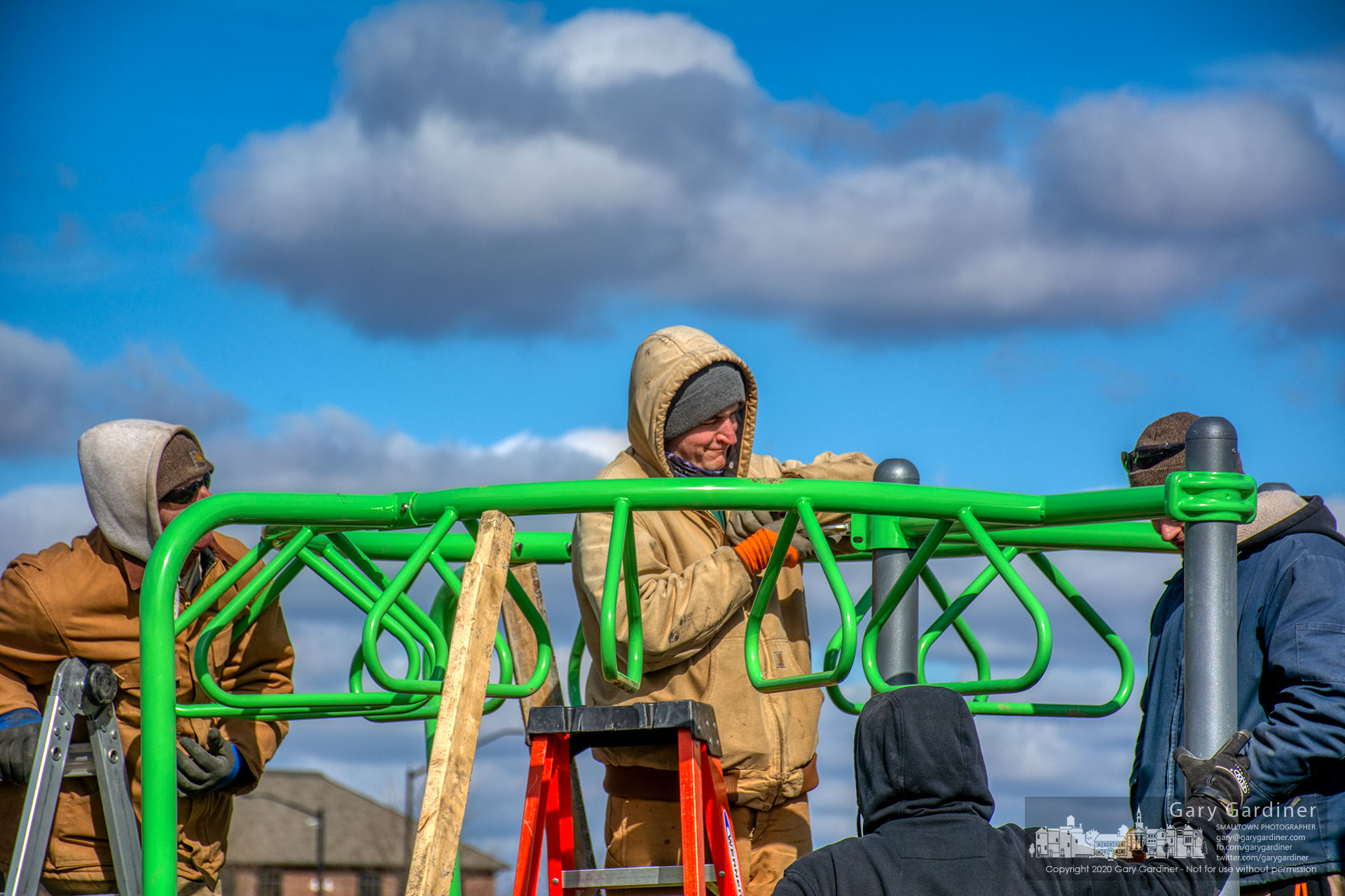 Under partly cloudy skies and below normal temperatures a Westerville Parks crew works to install new equipment on the redesigned playground at the sports fields across Cleveland Ave. from the community center. My Final Photo for Feb. 20, 2020.