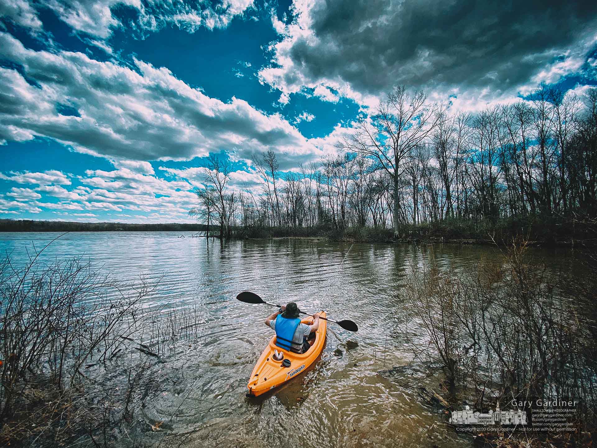 A fisherman uses his kayak to retrieve a snagged lure from the calm waters of the inlet at Red Bank Park on Hoover. My Final Photo for March 29, 2020.