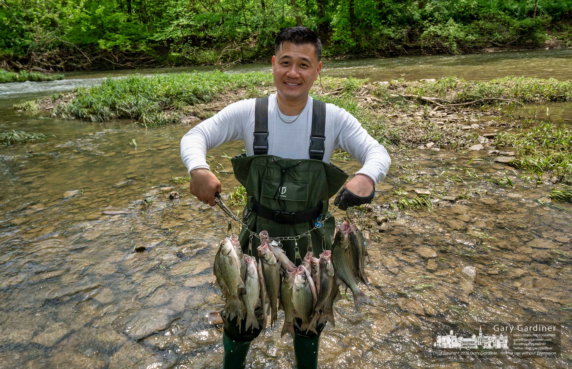 A fisherman proudly displays his catch from Big Walnut Creek in Galena before calling it a day on the rushing waters of the rain-swollen creek. My Final Photo for May 24, 2020.