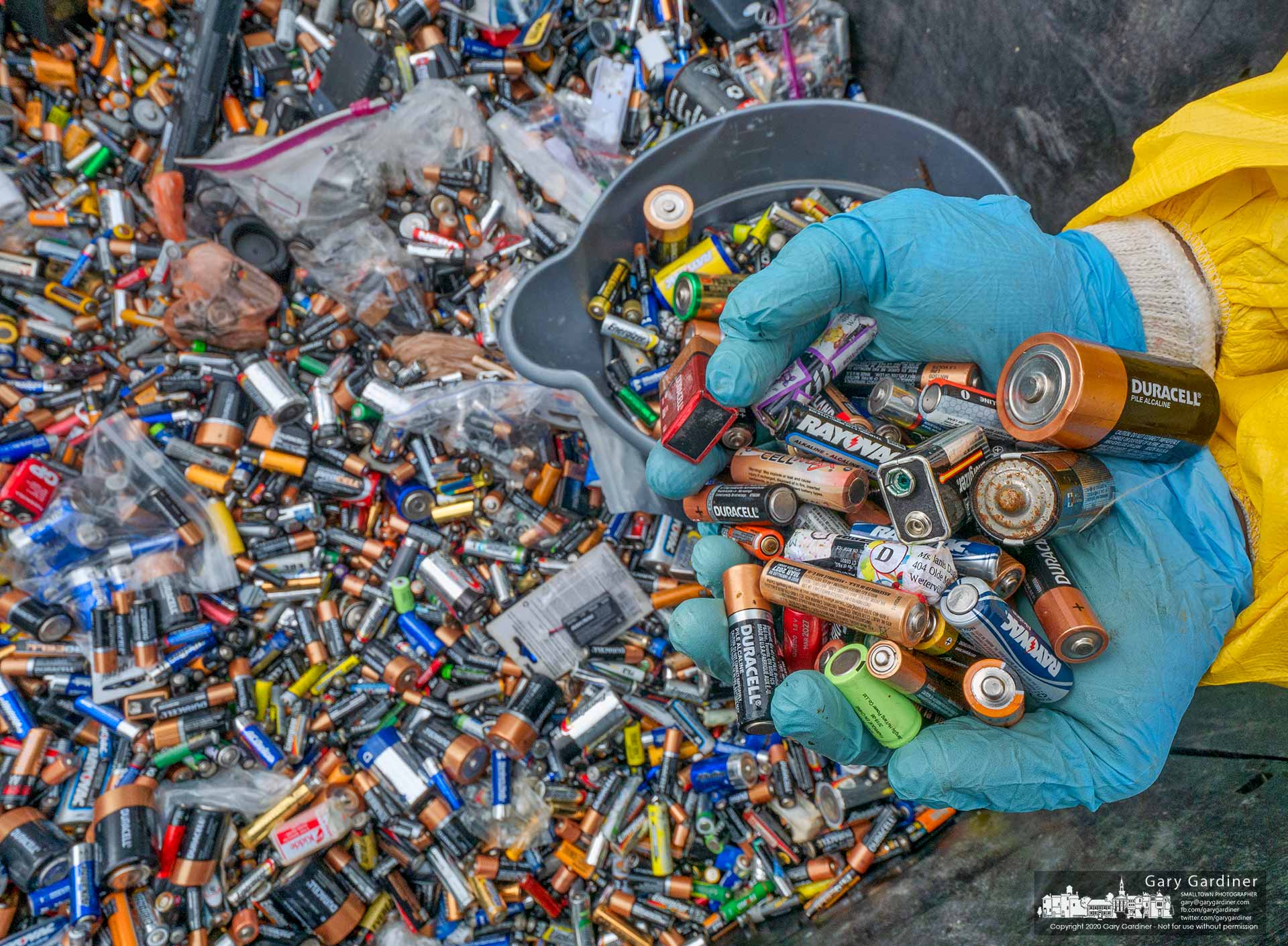 A disposal worker sorts through the thousands of batteries dropped off during the Household Hazardous Waste collection at the city building on Park Meadow Rd. My Final Photo for June 13, 2020.
