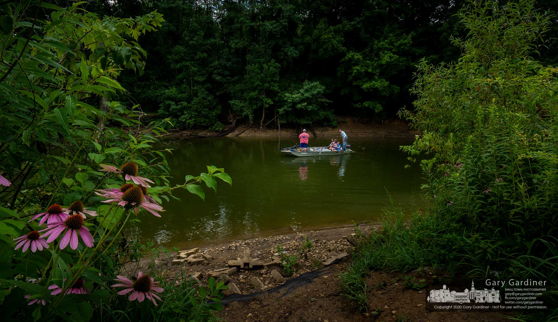 A pair of adult anglers share their boat and a pizza with three children as they navigate from the inlet at Red Bank Park near to where they picked up the to-go pizza. My Final Photo for Aug. 4, 2020.