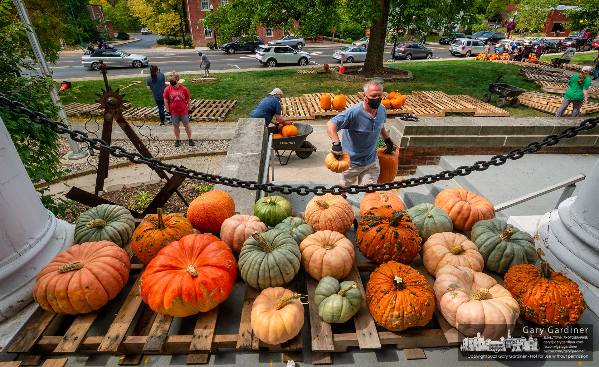 Boy Scouts and volunteers move a tractor-trailer of pumpkins into their best display locations for sale at the scout troop's annual pumpkin patch sale at the Masonic Hall on South State Street. My Final Photo for Sept. 26, 2020.