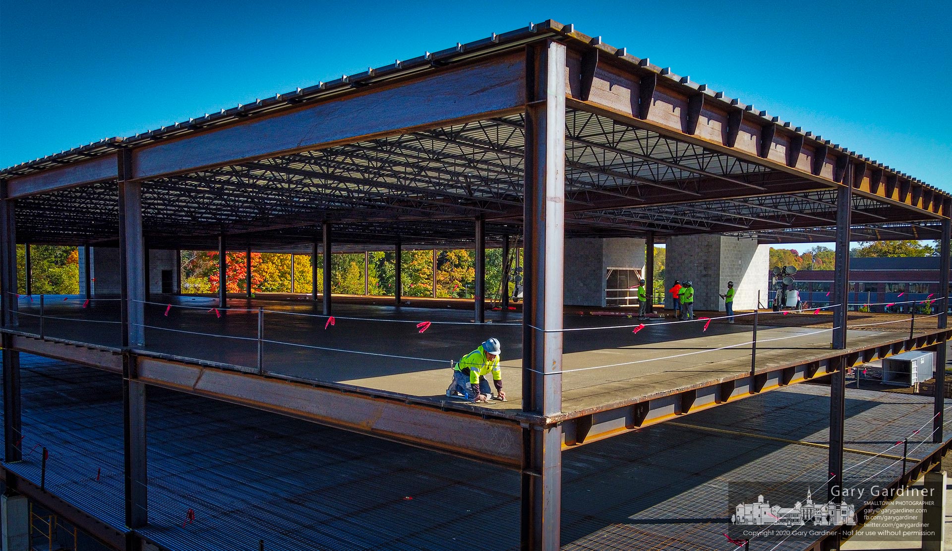 A construction worker smooths out the edges of a concrete pad poured for the third level floor of the COPC medical building under construction off Africa Road. My Final Photo for Oct. 8, 2020.
