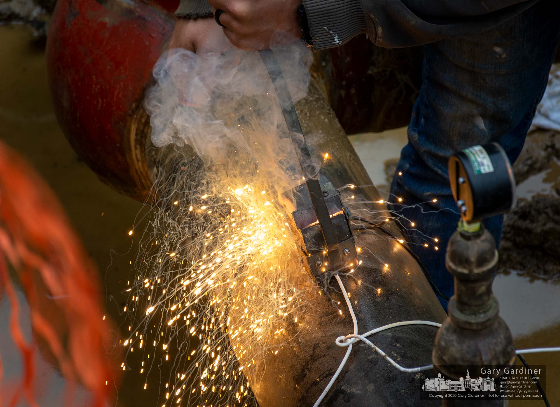 Sparks fly from an exothermic weld that attaches a copper cable to a steel gas pipeline helping create an anode connection to help prevent corrosion of the line being laid along Central Ave. in Westerville. My Final Photo for Oct. 20, 2020.