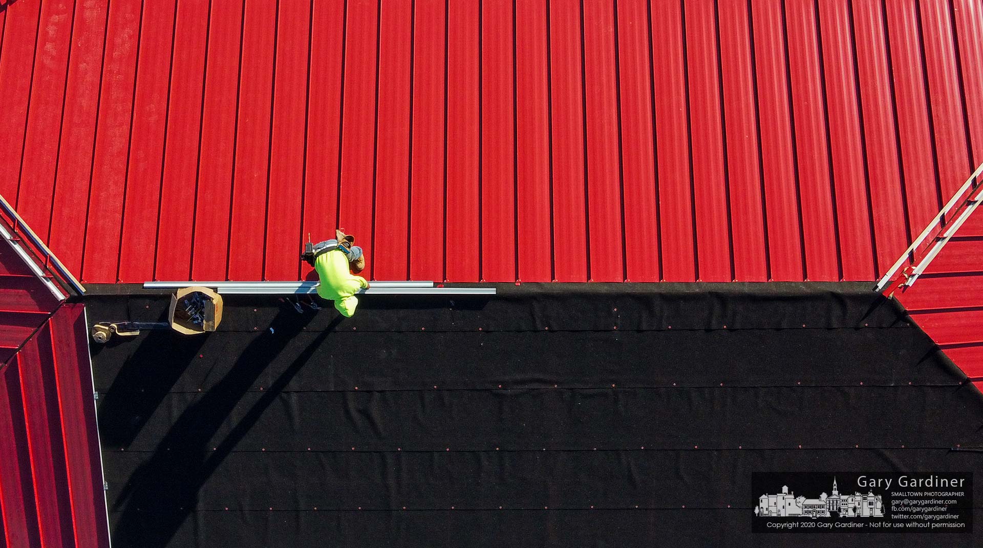 A worker installs a section of metal roofing on the office section of a new storage business being built on Maxtown Road. My Final Photo for Nov. 6, 2020.