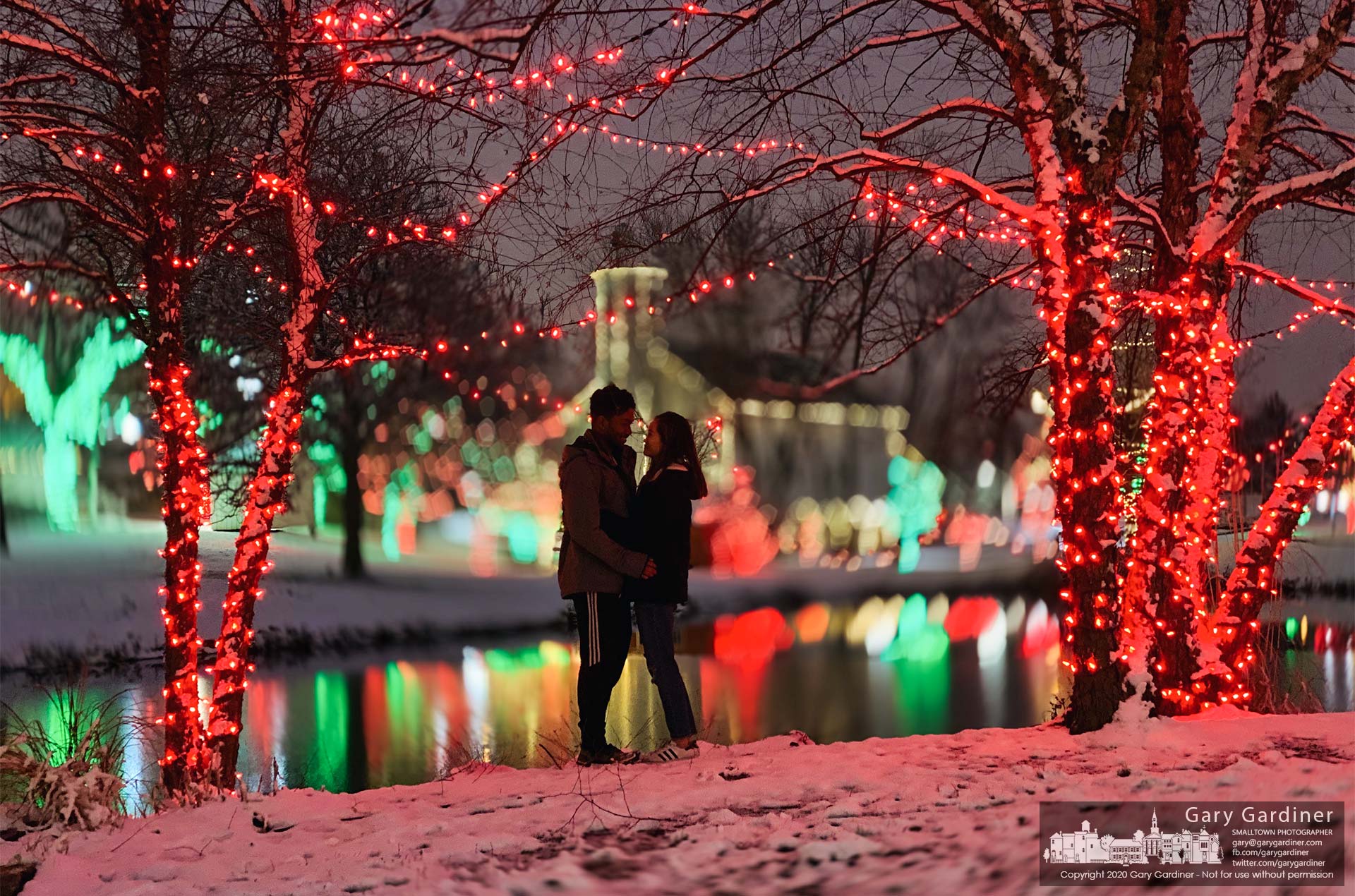 A young couple celebrating an anniversary poses for a photo among the Christmas lights at Heritage Park. My Final Photo for Dec. 17, 2020.