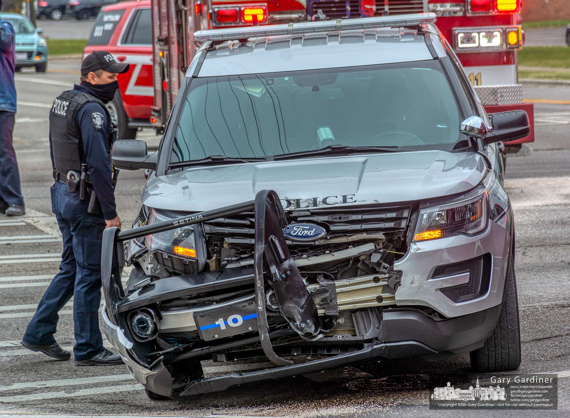 A Westerville Police officer looks over a cruiser damaged in a crash Monday afternoon at West Main and Cleveland Ave. My Final Photo for Dec. 7, 2020.