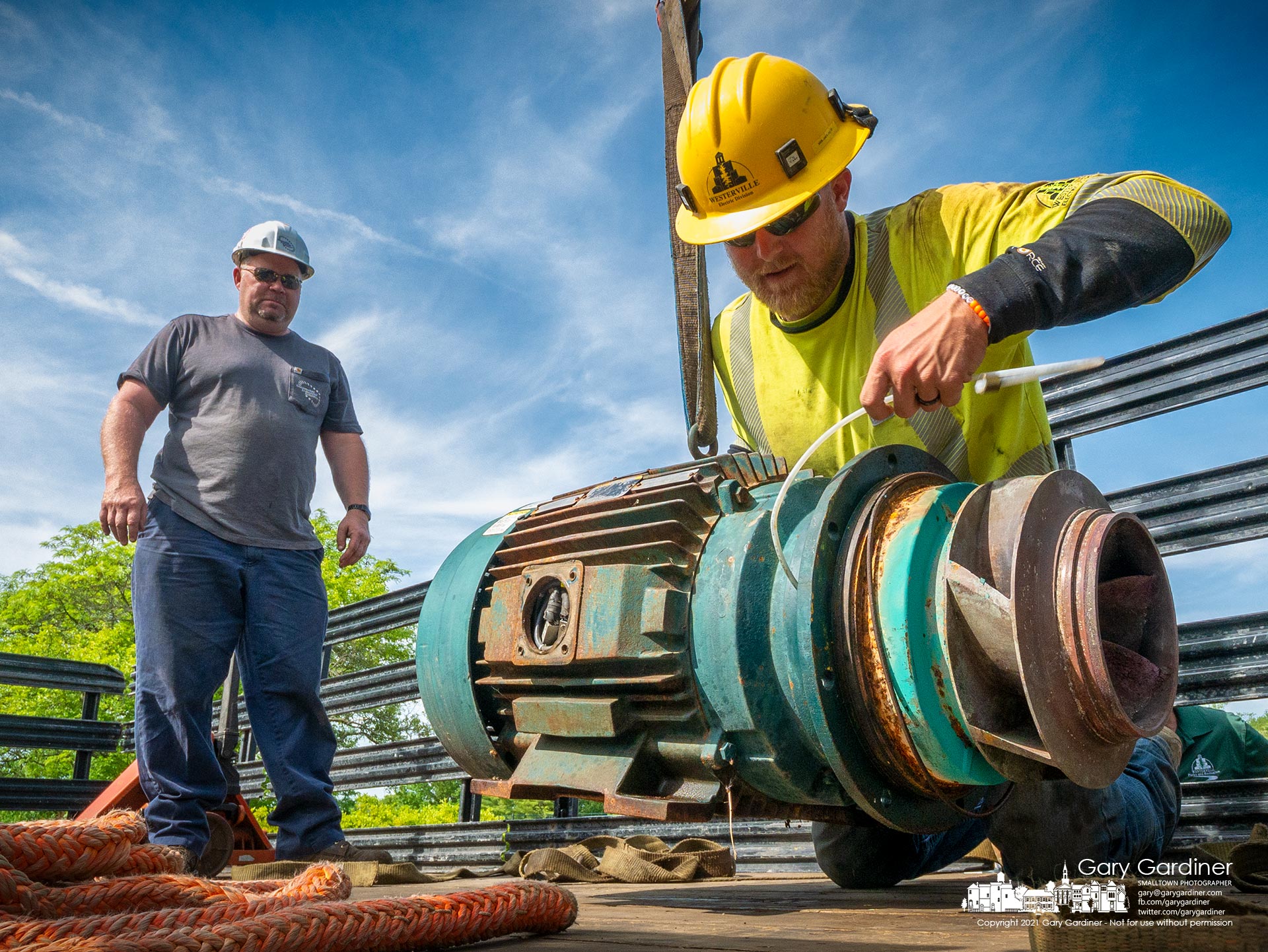 A city electric worker helps remove the broken impeller pump that provides water flow in The River at Highlands Pool when its bearings failed during testing for the pool's opening next weekend. My Final Photo for May 21, 2021.