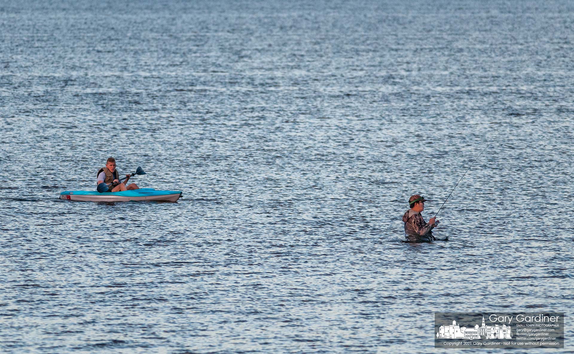 A kayaker wears a quizzical expression as he approaches a fisherman several hundred feet into Hoover Reservoir near the Walnut Street boat ramp. My Final Photo for Sept. 9, 2021.