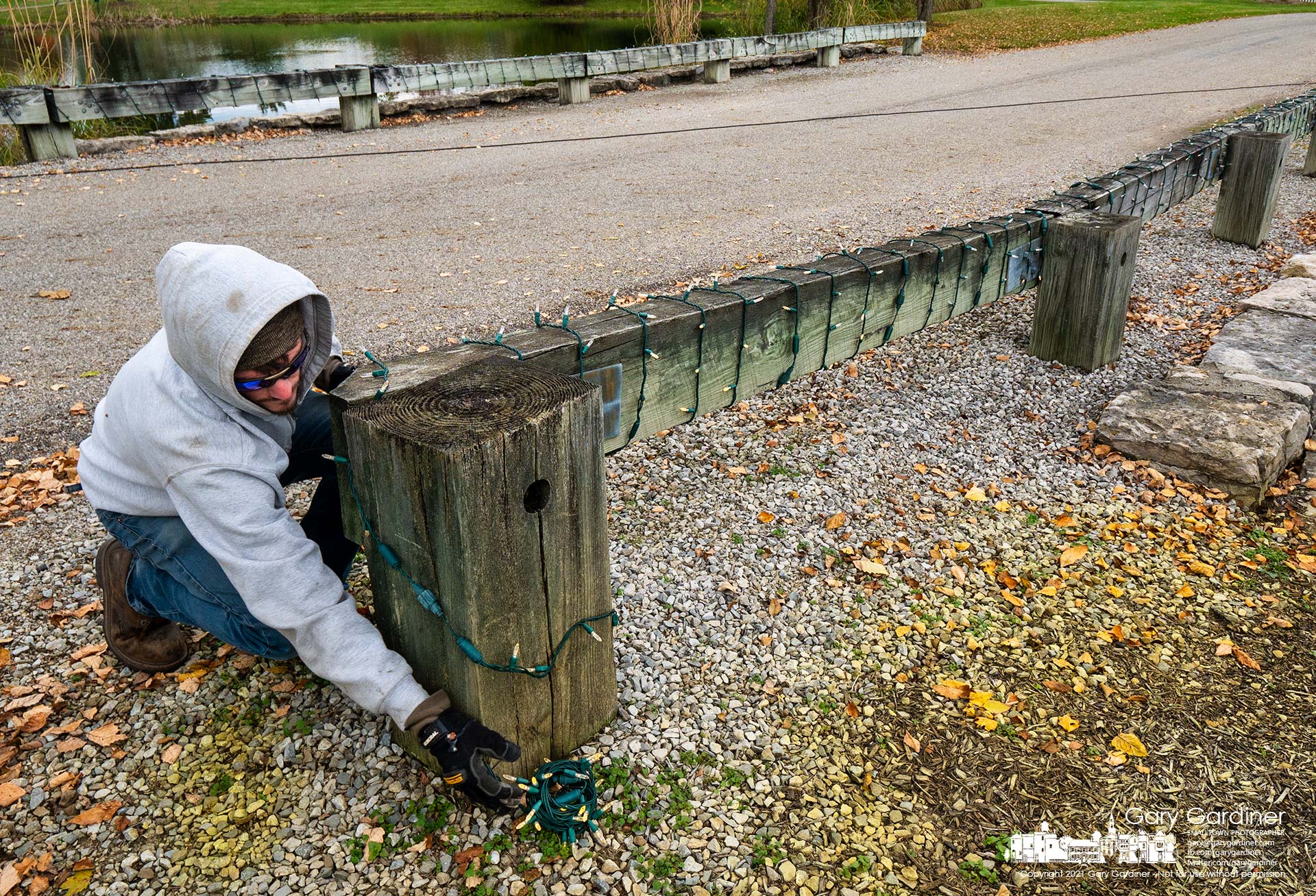 A Westerville Parks worker installs led lights on and around the bridge leading into Heritage Park at the city begins the installation of holiday lights at the park. My Final Photo for Nov. 4, 2021.