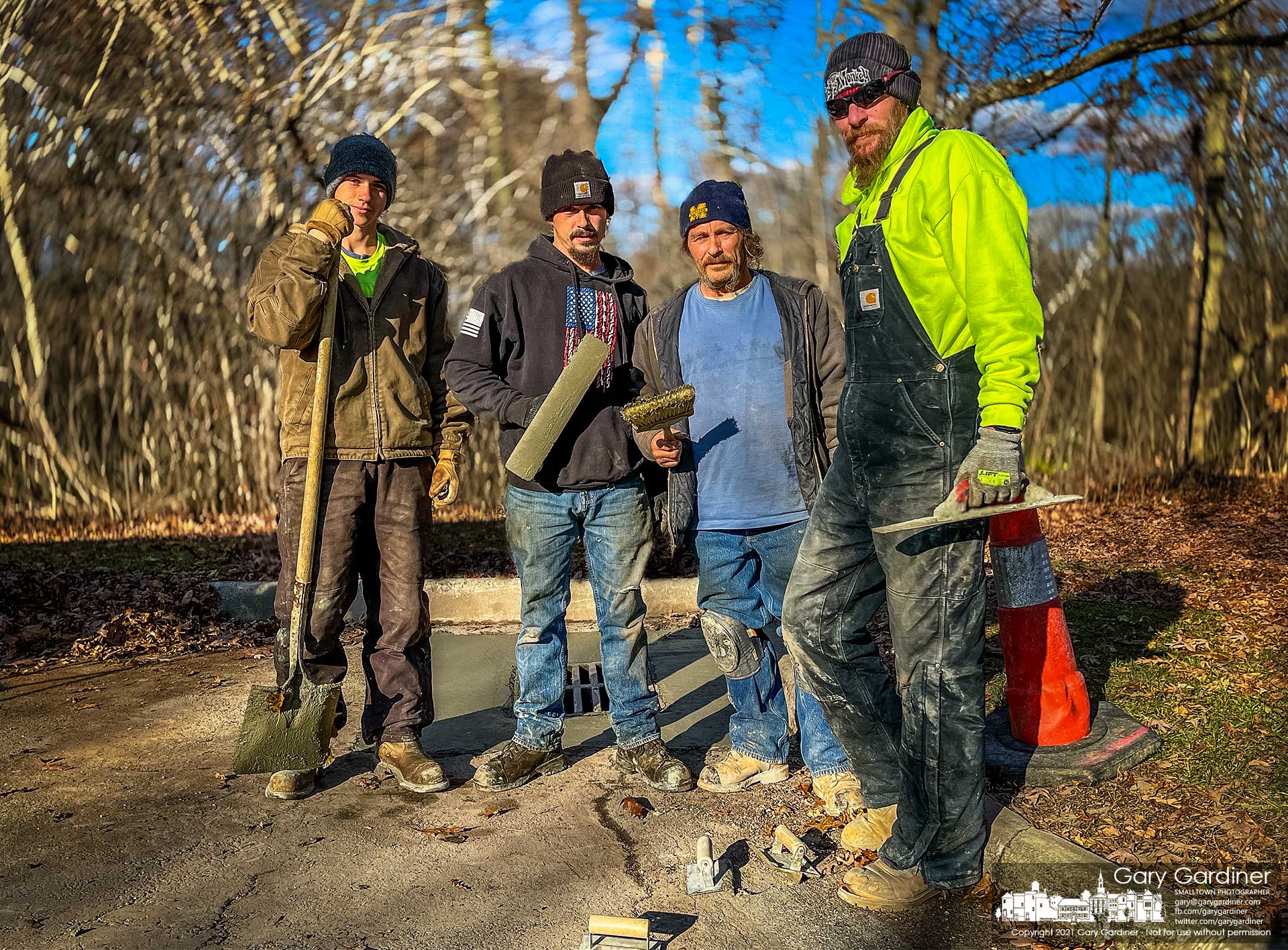 The four men working for a construction company pose for a photo after pouring a concrete pad around a drain in one of the parking lots at Sharon Woods Metro Park. My Final Photo for Nov. 23, 2021.