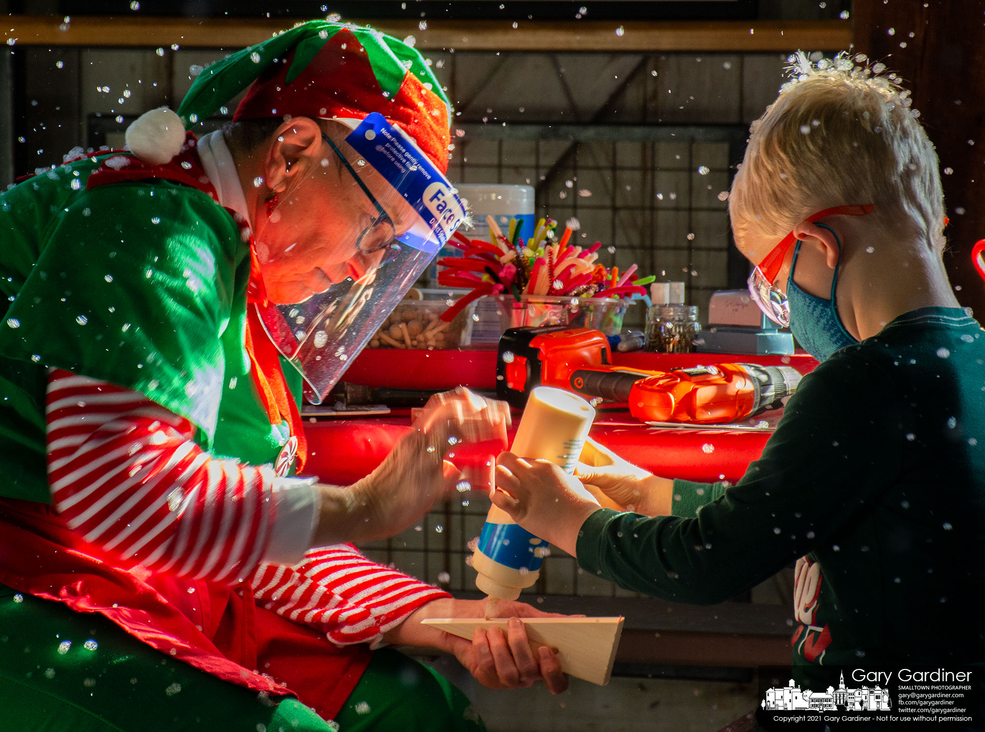 Under a flurry of sudsy snow, an elf assists her charge glue together the toy he's building at Westerville Parks Snowflake Castle in the barn at Heritage Park. My Final Photo for Nov. 29, 2021.
