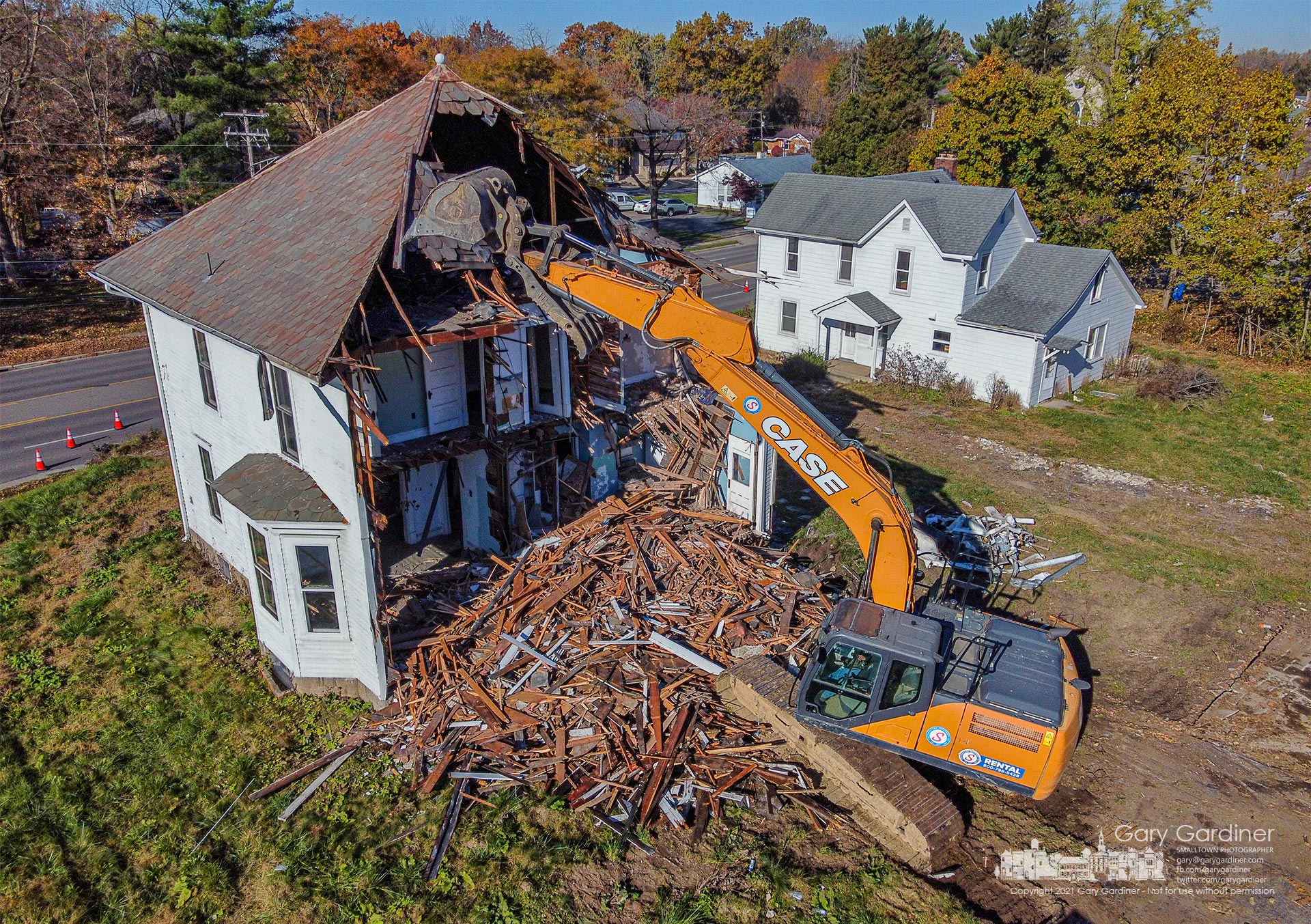 A work crew tears away the rear of the larger of two abandoned houses demolished Monday on South State Street to make way for a new structure housing business and apartments. My Final Photo for Nov. 8, 2021.