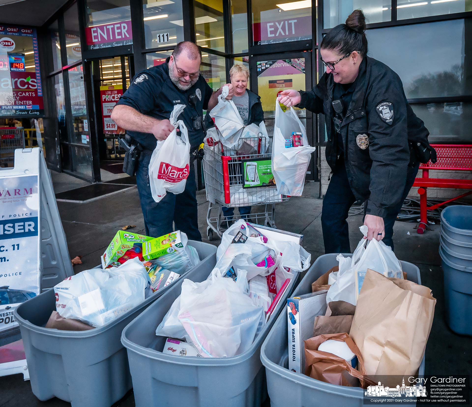 Westerville police officers offload bags of groceries donated by Mayor Kathy Cocuzzi to Westerville Area Resource Ministry's Fill-A-Cruiser campaign to provide for needy families at Christmas. My Final Photo for Dec. 11, 2021.