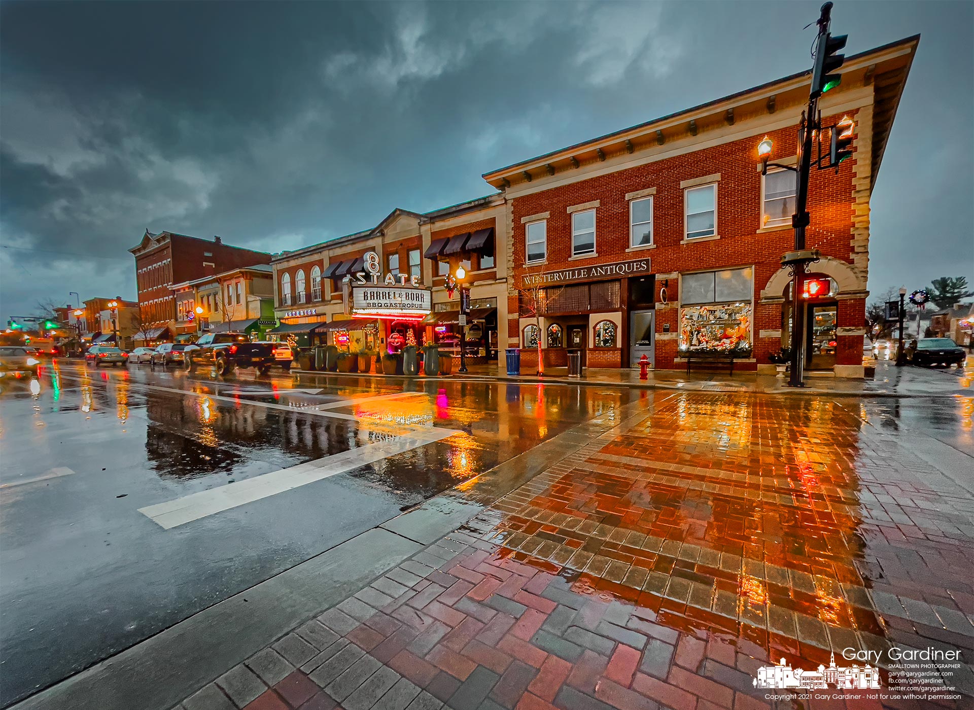 The buildings and lights of Uptown Westerville are reflected in rain-covered streets after a near day-long rainstorm. My Final Photo for Dec. 16, 2021.