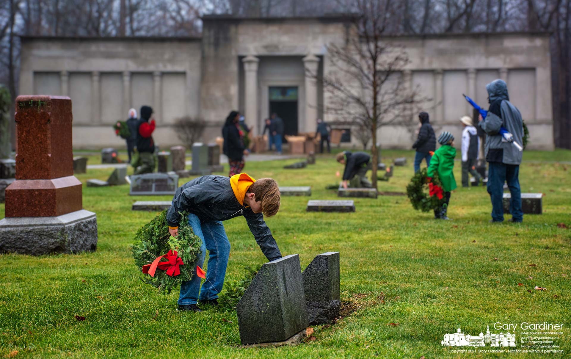 Volunteers lay wreaths at graves in Otterbein Cemetery as part of the national Wreaths Across America program that honors military veterans. My Final Photo for Dec. 18, 2021.