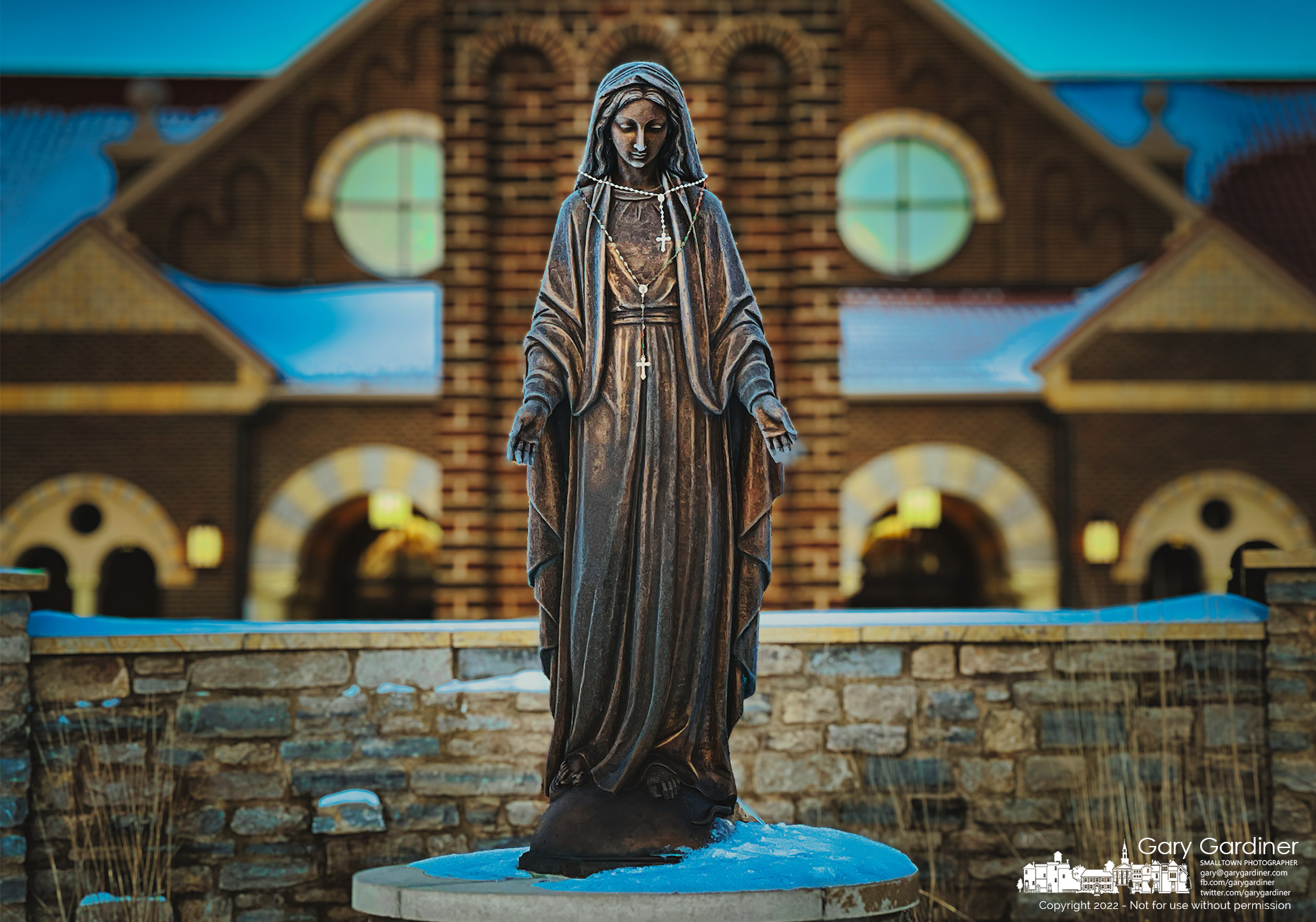 The statue of Mary wears a pair of rosaries and a layer of frost just minutes after sunrise on Sunday morning before the first Mass. My Final Photo for February 6, 2022.