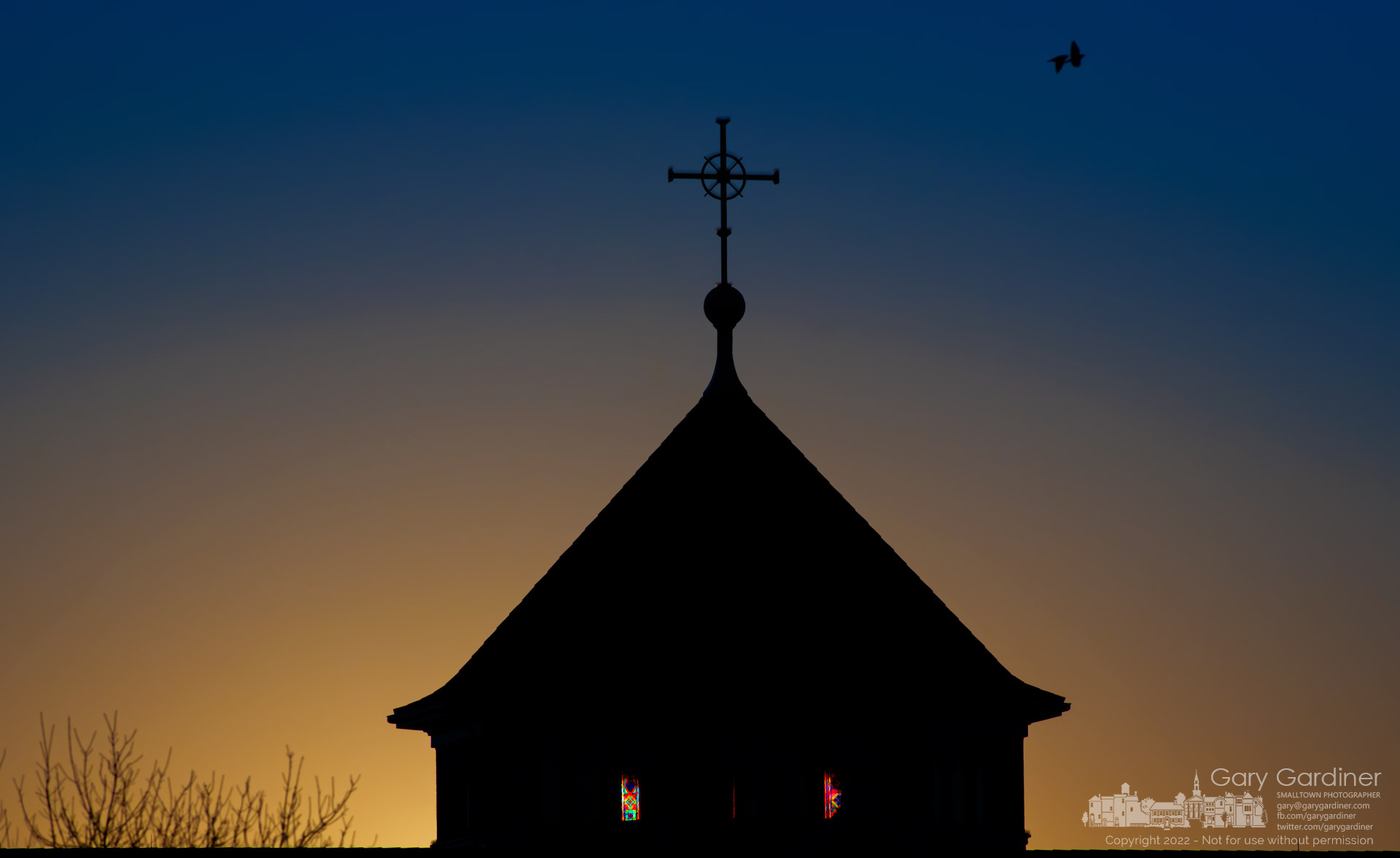 The morning sun rises behind the St. Paul the Apostle Catholic Church steeple illuminating a few of the stained glass windows. My Final Photo for Feb. 20, 2022.