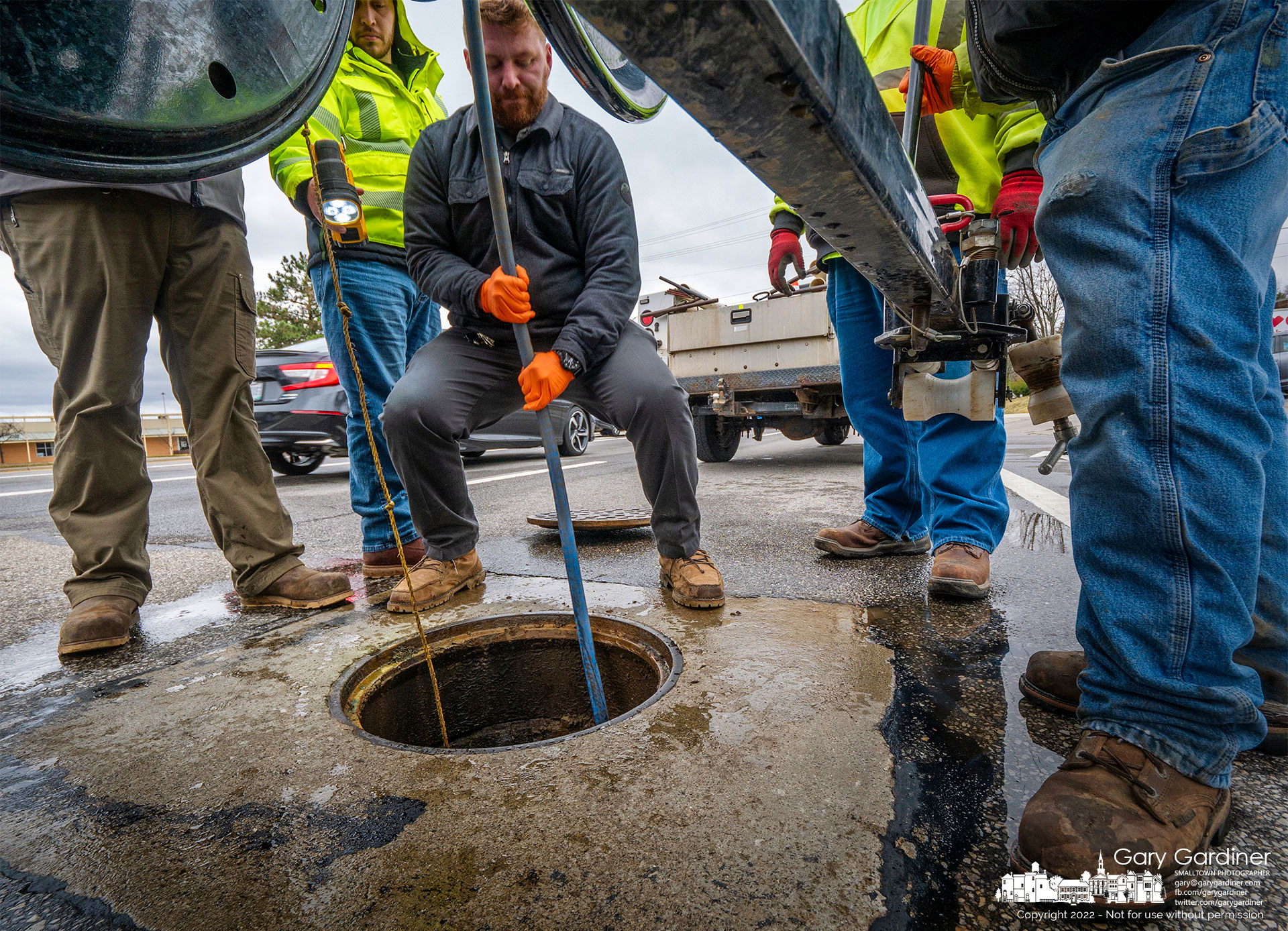 A group of city workers struggles to clear a blocked sanitary sewer pipe that runs beneath Schrock Road near Cleveland Ave. after it was blocked by what appeared to be a root ball causing a backup in several businesses including a dentist's office. My Final Photo for March 7, 2022.