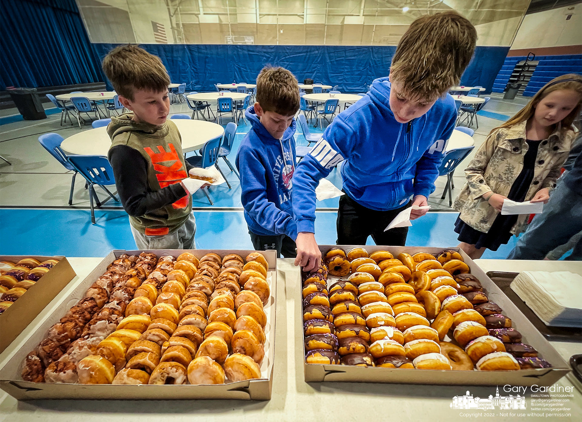 Eager children are the first in line to make their choice from the hundreds of doughnuts offered at the first Sunday doughnuts and coffee at St. Paul the Apostle Catholic Church for two years when social gatherings were limited because of the covid epidemic. My Final Photo for March 27, 2022.