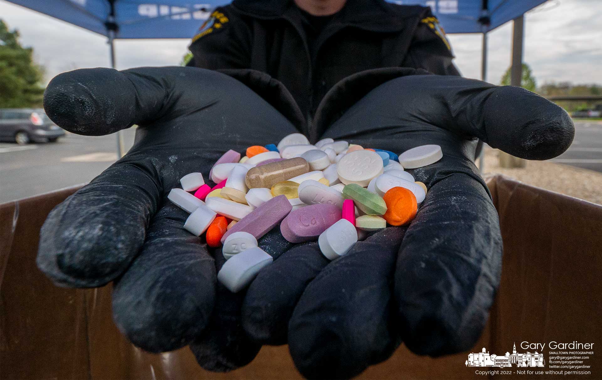 A Blendon Township officer shows a very small portion of the drugs recovered during Saturday's Drug Take Back Day where police agencies collected unused and not needed drugs for disposal. My Final Photo for April 30, 2022.