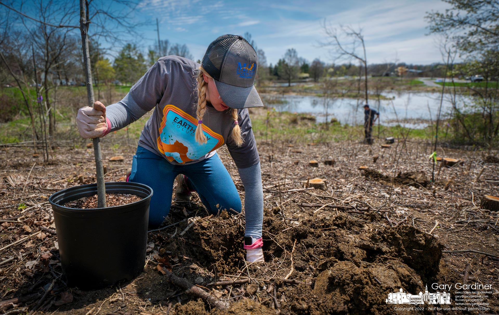 MAD Scientist's Jenny Adkins plants a white oak tree on the small hill at the north end of the Highlands wetlands where an earlier crew removed the overgrowth from invasive species such as Bradford pears and honeysuckle. My Final Photo for April 20, 2022.