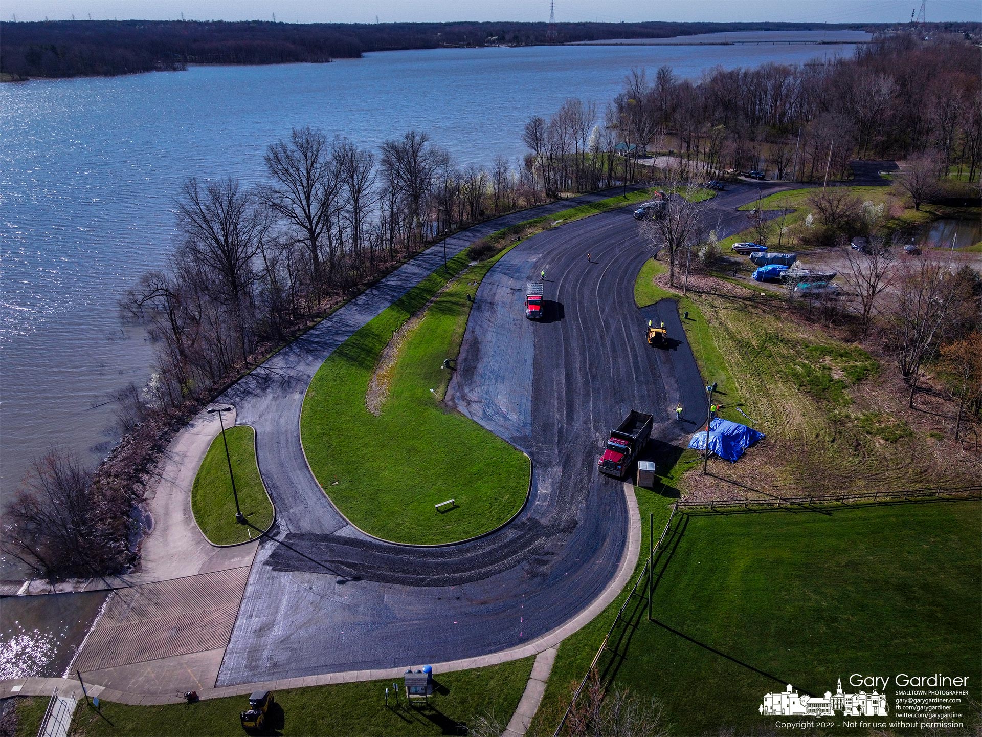 A contractor begins laying a new layer of asphalt across the parking lot at Red Bank marina on Hoover Reservoir after removing the old surface and repairing the gravel underlayer. My Final Photo for April 15, 2022.