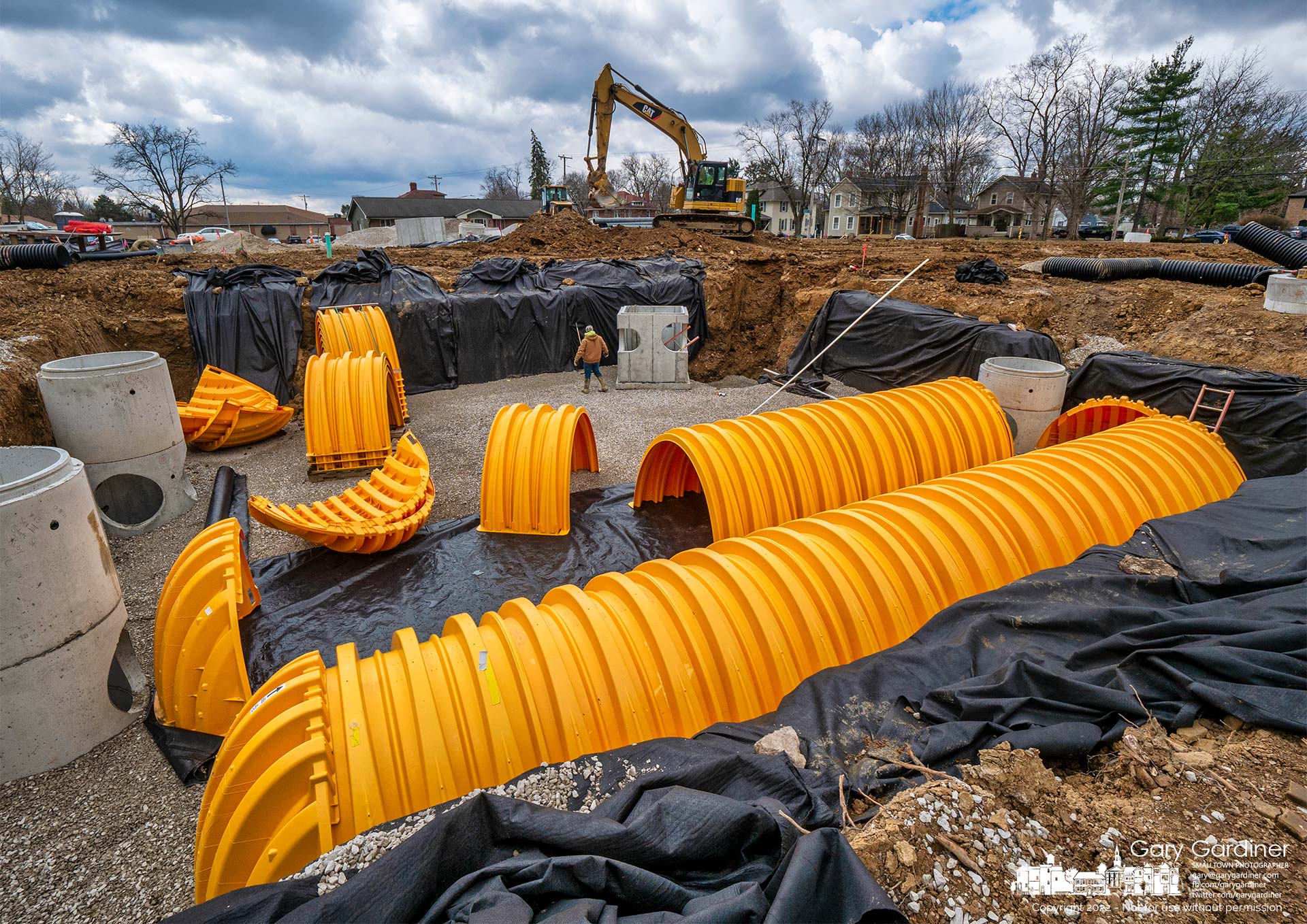 Sections of corrugated plastic pipes are placed in an underground stormwater holding pond beneath the parking lot of a business and apartment complex being built on South State Street. My Final Photo for April 1, 2022.
