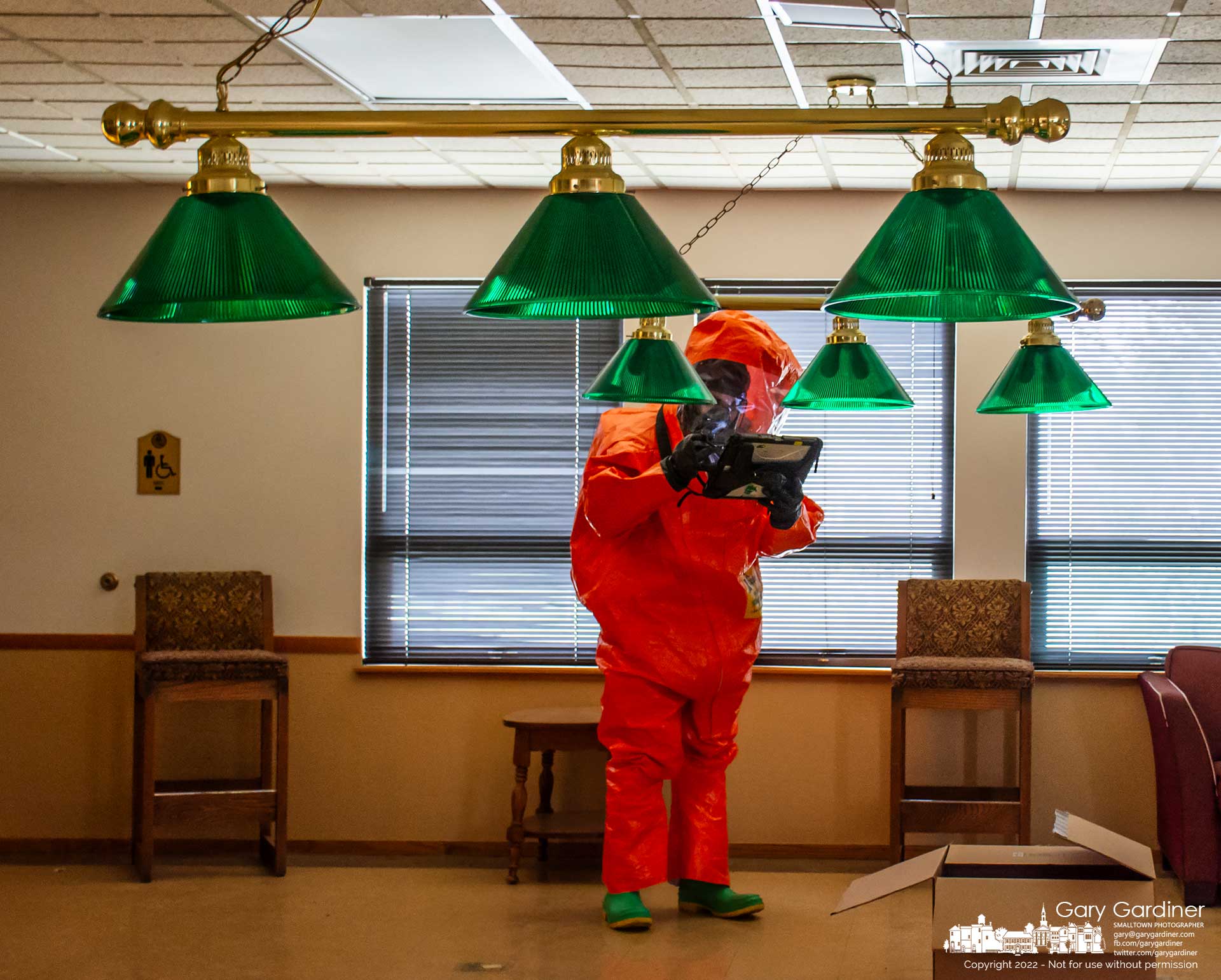 An Ohio National Guard soldier wearing protective gear checks the readout on a portable monitor as he walks through the pool table room at the old Westerville Senior Center during a training session for the detection of weapons of mass destruction by the Guard's 52nd Civil Support Team. My Final Photo for April 7, 2022.