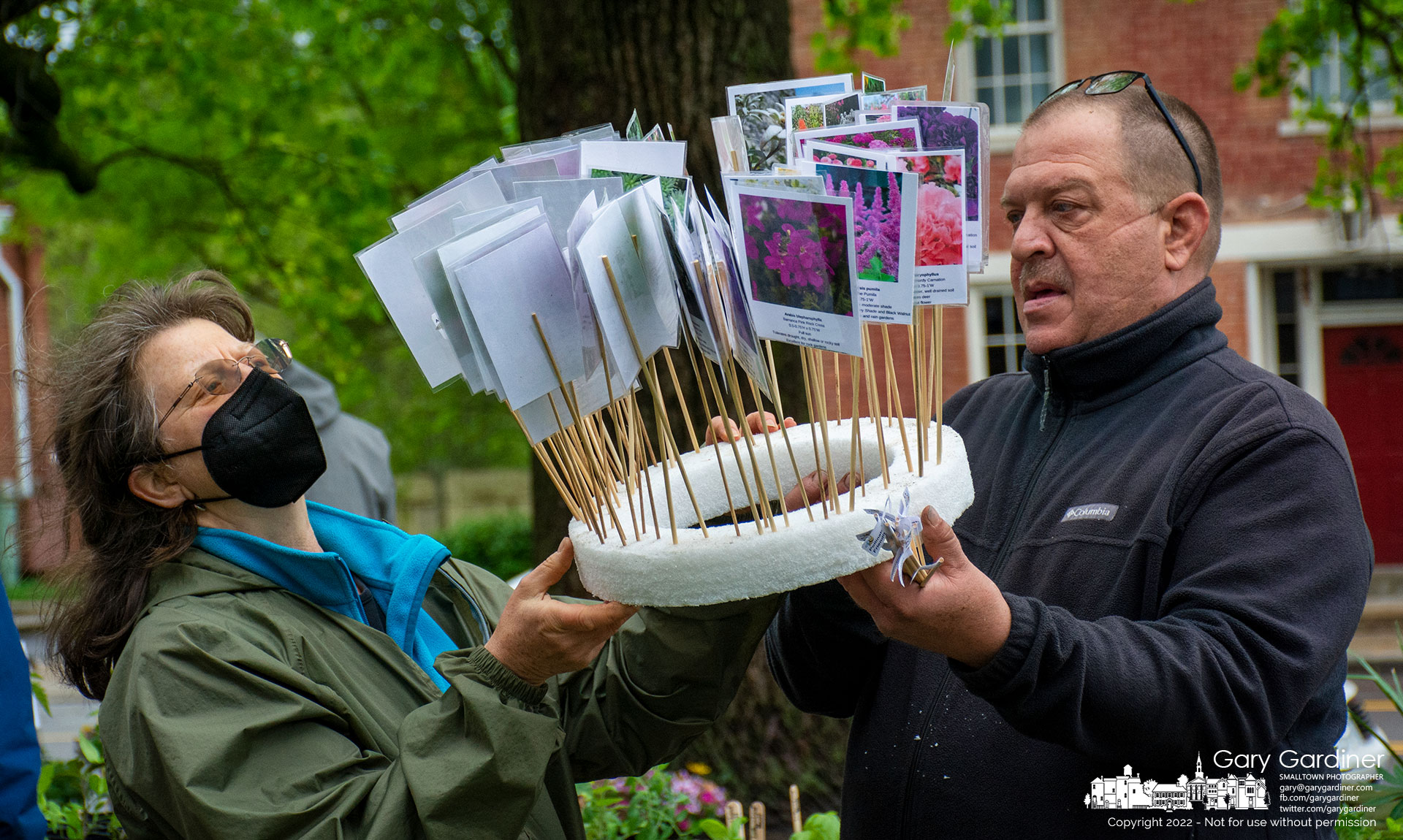 Westerville Garden Club volunteers sort through descriptive tags to be placed in flower pots for correct identification at the club's annual plant sale in front of the Masonic Temple on South State Street. My Final Photo for May 7, 2022.
