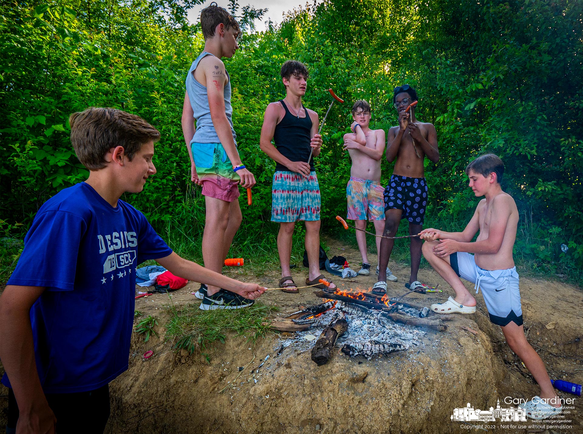 A group of boys roast hotdogs on the fire they started on the shoreline of Hoover Reservoir taking advantage of a warm Spring day after school. My Final Photo for May 25, 2022.