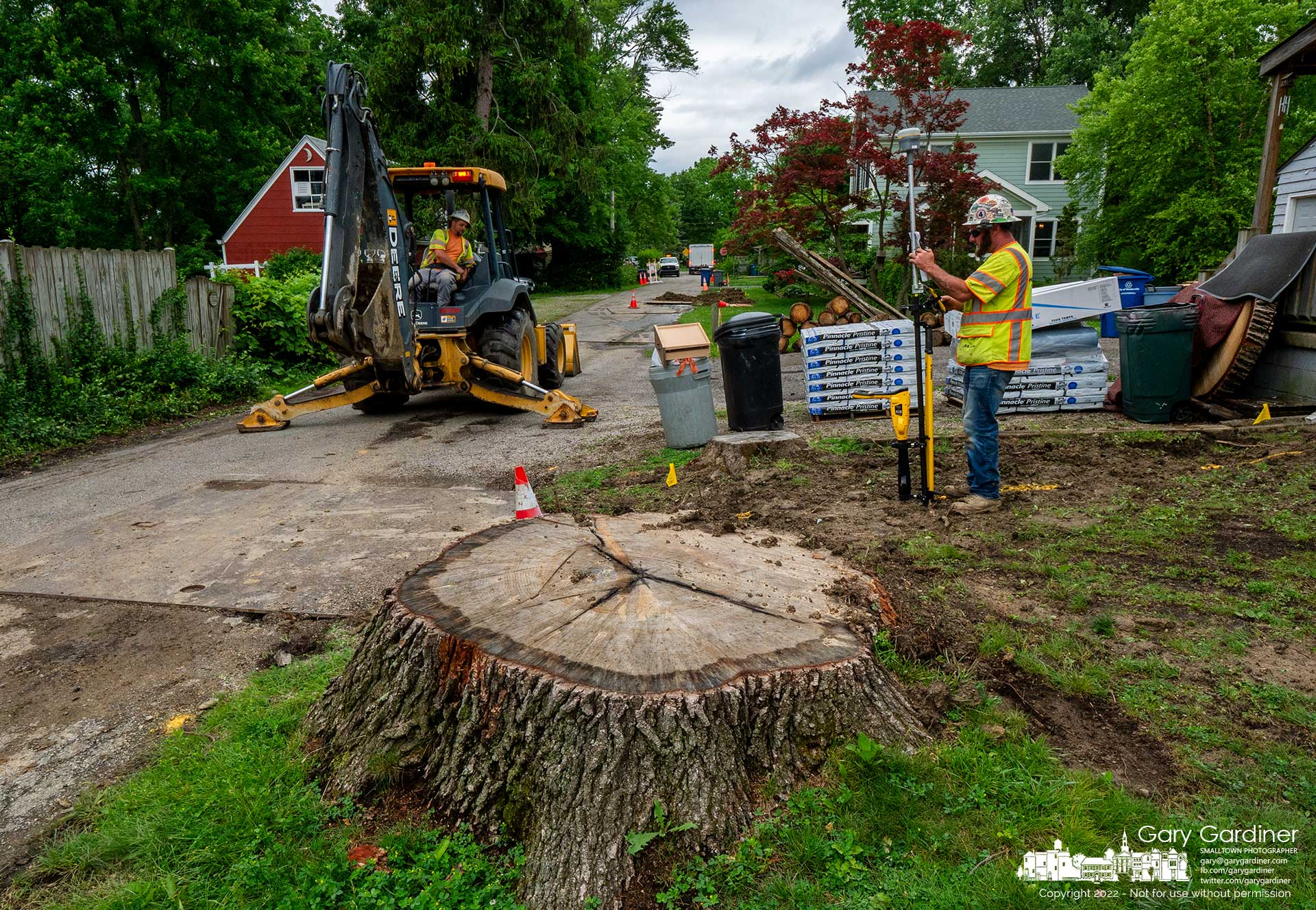 A pipeline crew uses a GPS locator to register location data for new gas lines installed during road construction along East Home Street and Whitehead. My Final Photo for June 7, 2022.