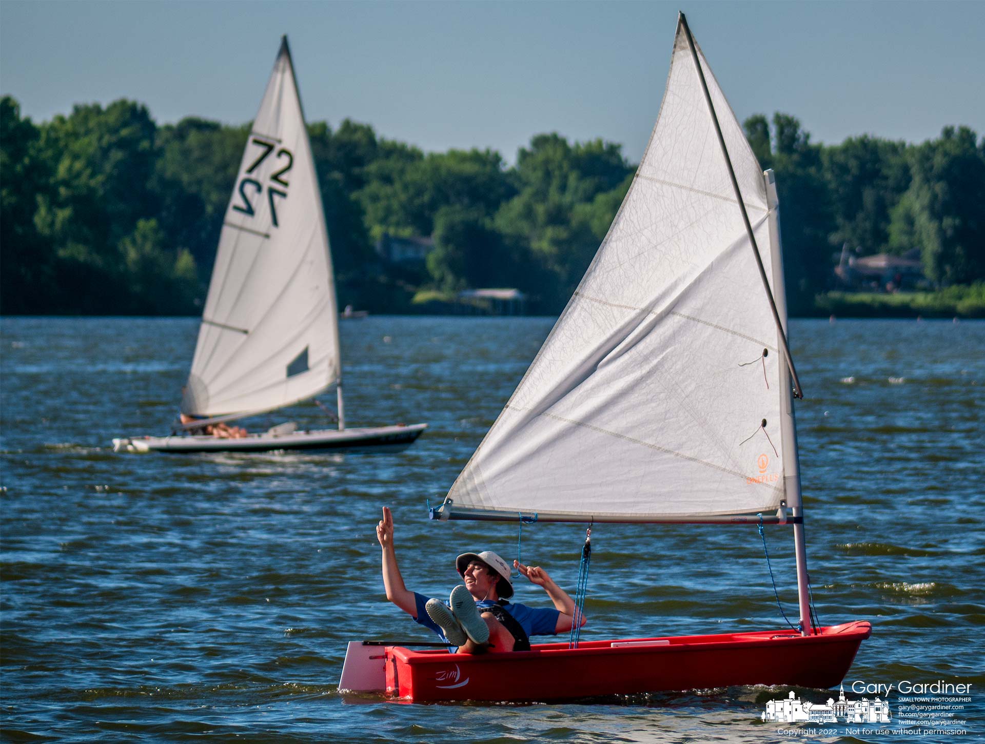 A sailor signals another small sailboat during an afternoon enjoying the waters of Hoover Reservoir. My Final Photo for June 23, 2022.